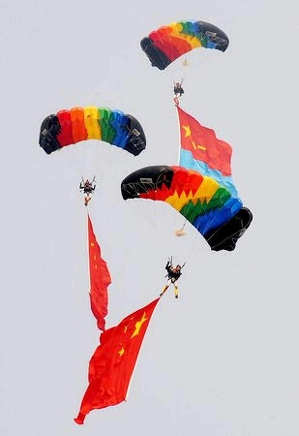 Parachutists perform aerobatics during China International Aviation and Aerospace Exhibition (also known as Airshow China and Zhuhai Airshow) in Zhuhai, China.
