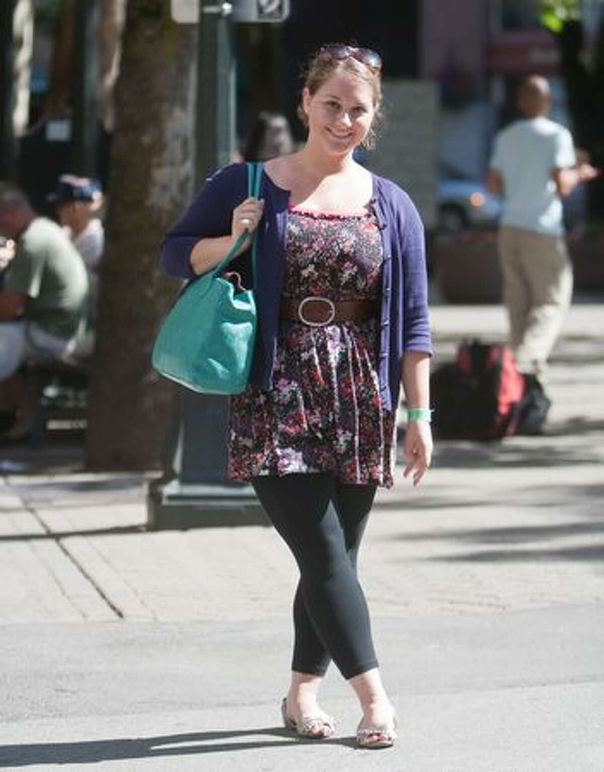 Rebekah Hess mixes it up with her layered look dressing her summer dress with a purple sweater. She completes her sassy summer look with a complimenting turquoise bag and silver slip-ons.
