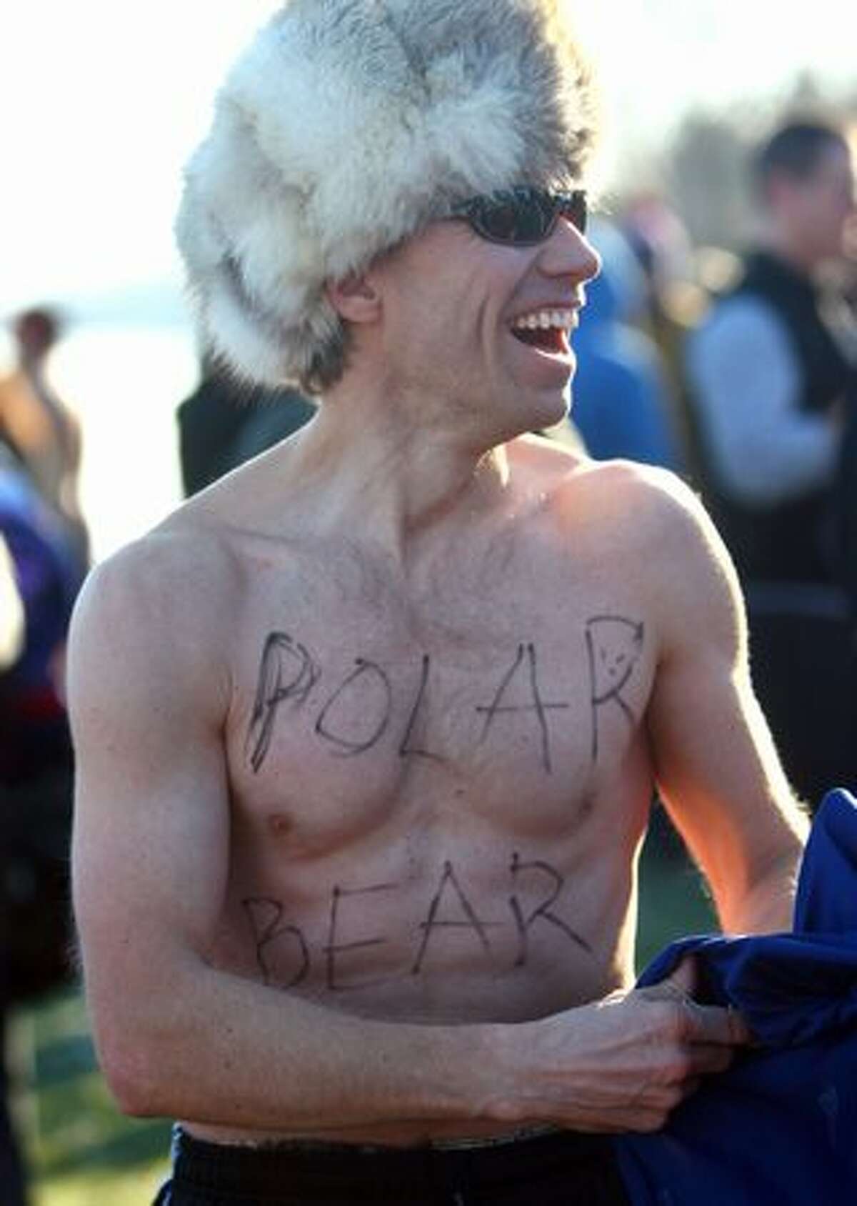 Paul Yetter prepares to dive in during the annual Polar Bear Plunge Saturday at Matthews Beach on Lake Washington.