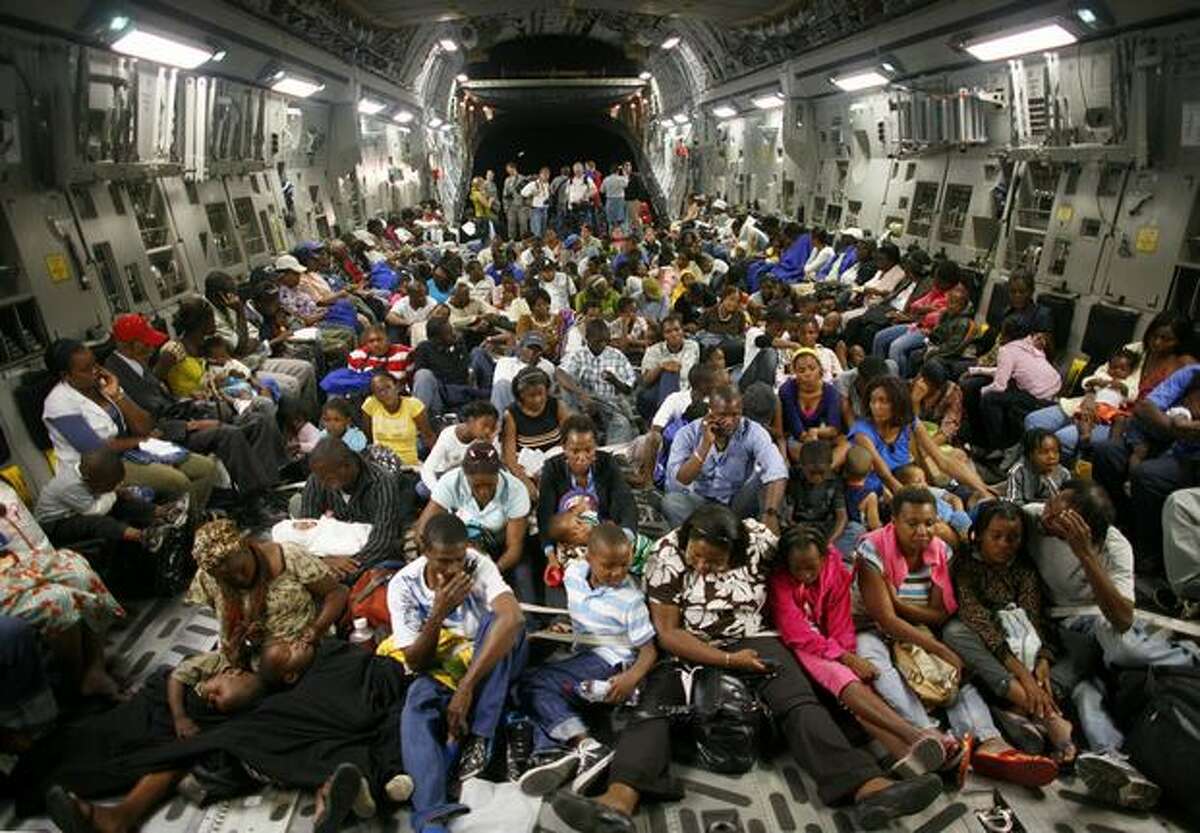 Nearly 200 evacuees are strapped to the floor of a C-17 Globemaster III at the Port-Au-Prince airport. The aircraft and its crew from McChord Air Force Base participated in a massive airlift of personnel and relief supplies into earthquake-damaged Haiti. Evacuees were taken from Port-Au-Prince to Orlando, Florida.