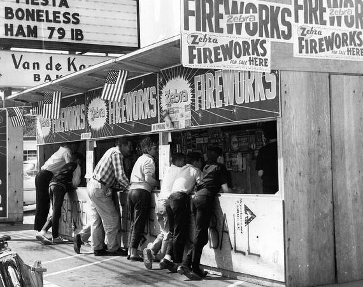 Customers at a Kenmore fireworks stand on July 2, 1963.