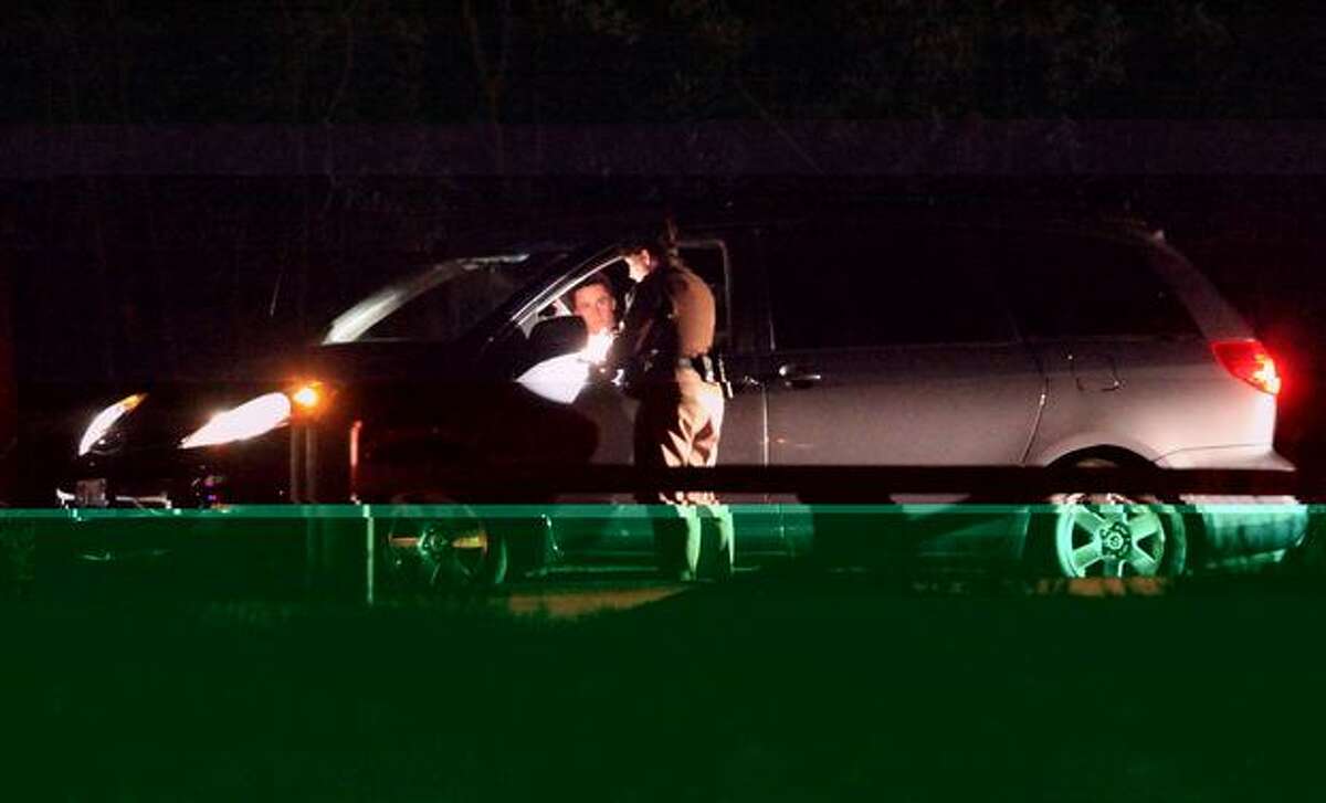 Police interview and inspect cars leaving Lake Sammamish State Park after a shooting left at least two dead and four others wounded Saturday night. The park was placed in lockdown afterward and park-goers were not allowed to leave without being questioned and cleared by police.