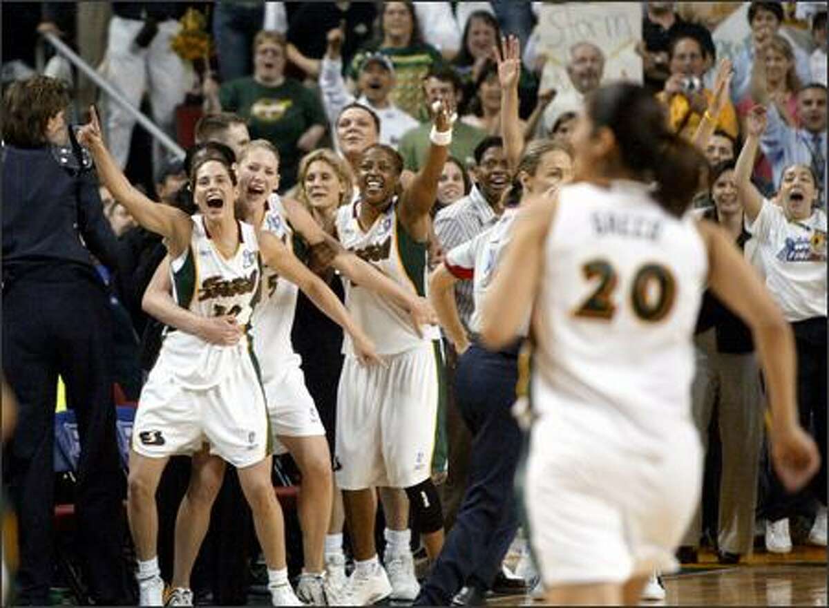 Seattle Storm players celebrate their first WNBA title after beating the Connecticut Sun 74-60 in the deciding Game 3 at KeyArena.