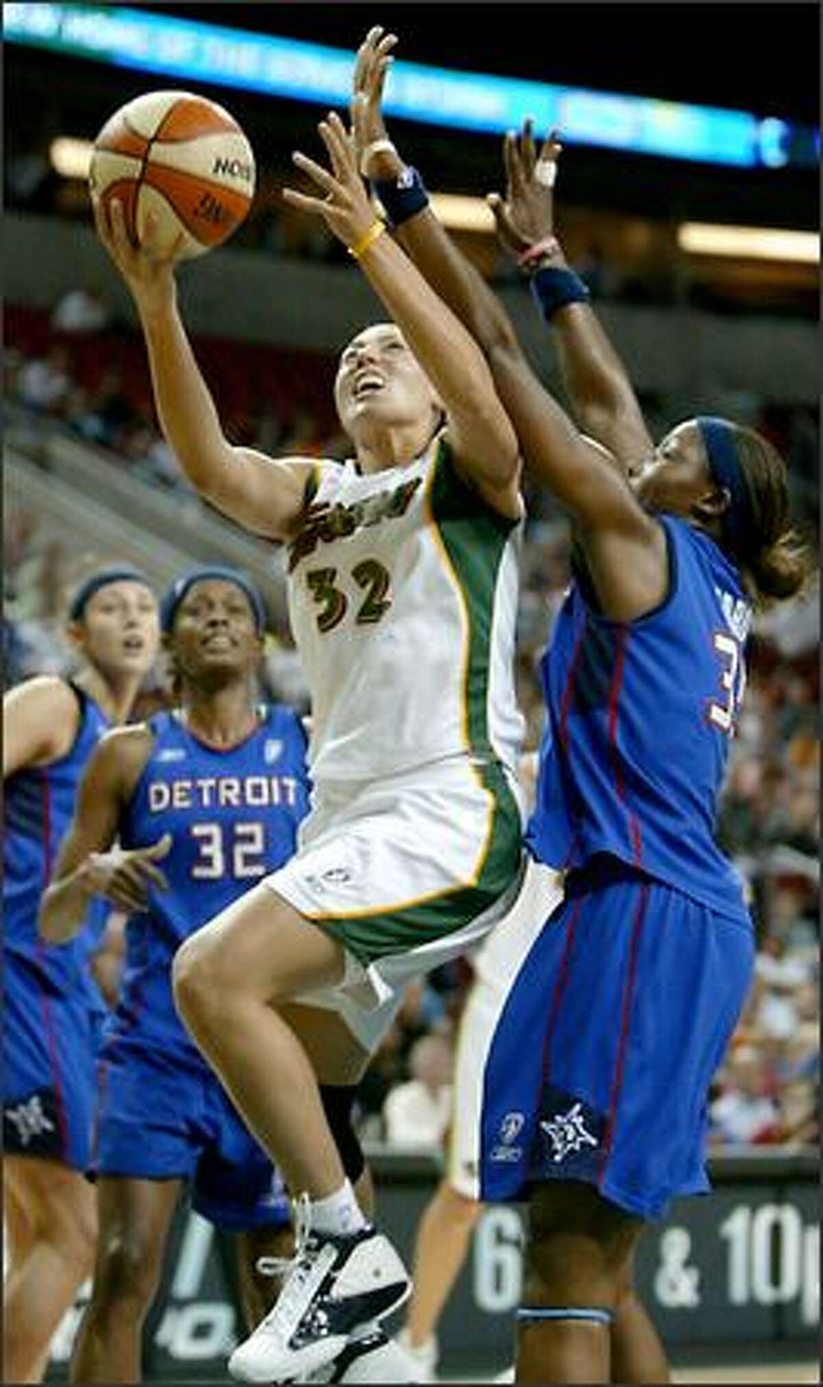 Seattle's Adia Barnes drives to the hoop as Detroit's Cheryl Ford tries for the block.