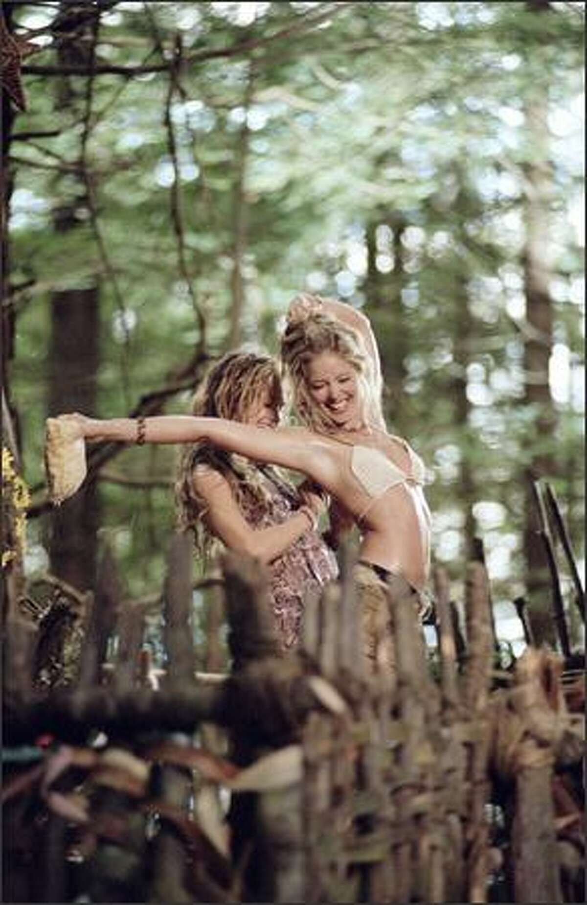 Rachel Blanchard as Flower (left) and Christina Moore as Butterfly are two of the backwoods characters who disrupt the three friends' expedition.