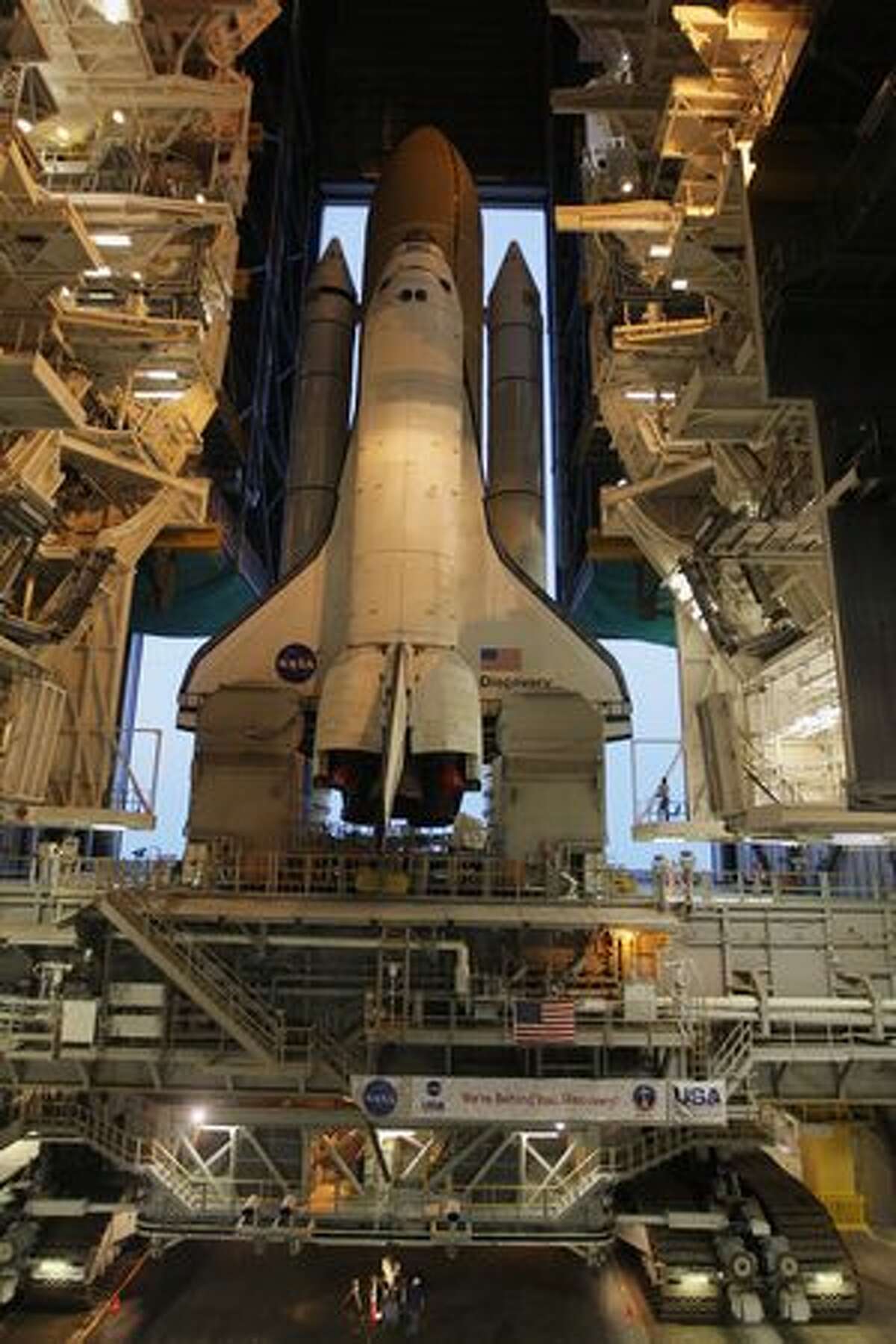 Space shuttle Discovery rolls out of NASA's vehicle assembly building atop a crawler transporter to launch pad 39 A at Kennedy Space Center in Cape Canaveral, Fla.