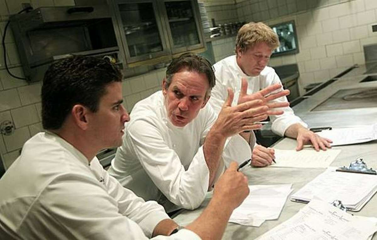 French Laundry executive chef Thomas Keller, center, confers with his chef de cuisine, Timothy Hollingsworth, right, and sous chef Anthony Secviar, left, as the team of chefs changes the menu.