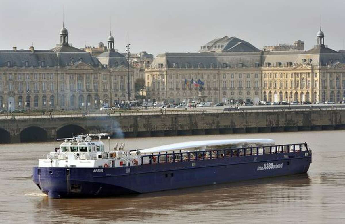 A barge carrying an Airbus A380 wing sails on the Garonne river in Bordeaux. The wings, assembled in Broughton, U.K., are transported by road and river craft to Mostyn harbour, loaded onto a custom-built roll-on, roll-off ferry for the trip to Pauillac harbour, France, barged to Langon and then sent by road to the Toulouse Airbus assembly line.