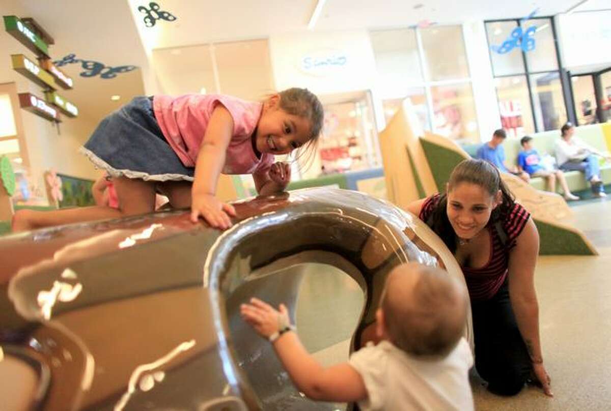 Casi Jackson plays with her daughters Trinity, 4, and Tiana, then 8 months, during a supervised visit at Southcenter Mall in Tukwila on Aug. 4