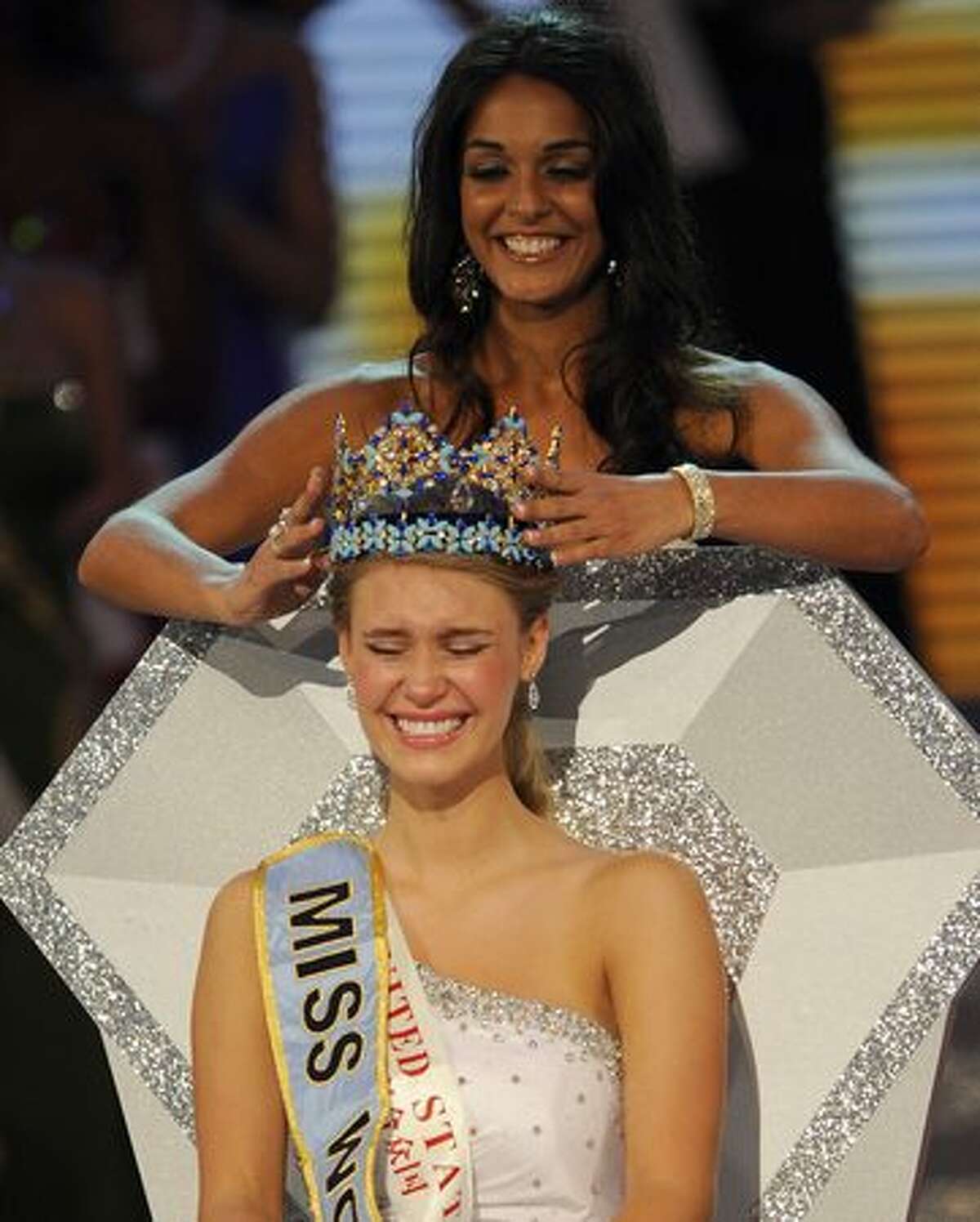 Alexandria Mills (seated) of the United States is crowned as the 2010 Miss World by 2009 Miss World Kaiane Aldorino from Gibraltar during the Miss World 2010 beauty pageant finals at the Beauty Crown Theatre in the southern Chinese resort town of Sanya on Saturday, Oct. 30, 2010. It was only the third win for the U.S. in the 60-year history of the pageant and the first in 20 years. Mills, 18 and a recent high school graduate, is from Louisville, Ky.