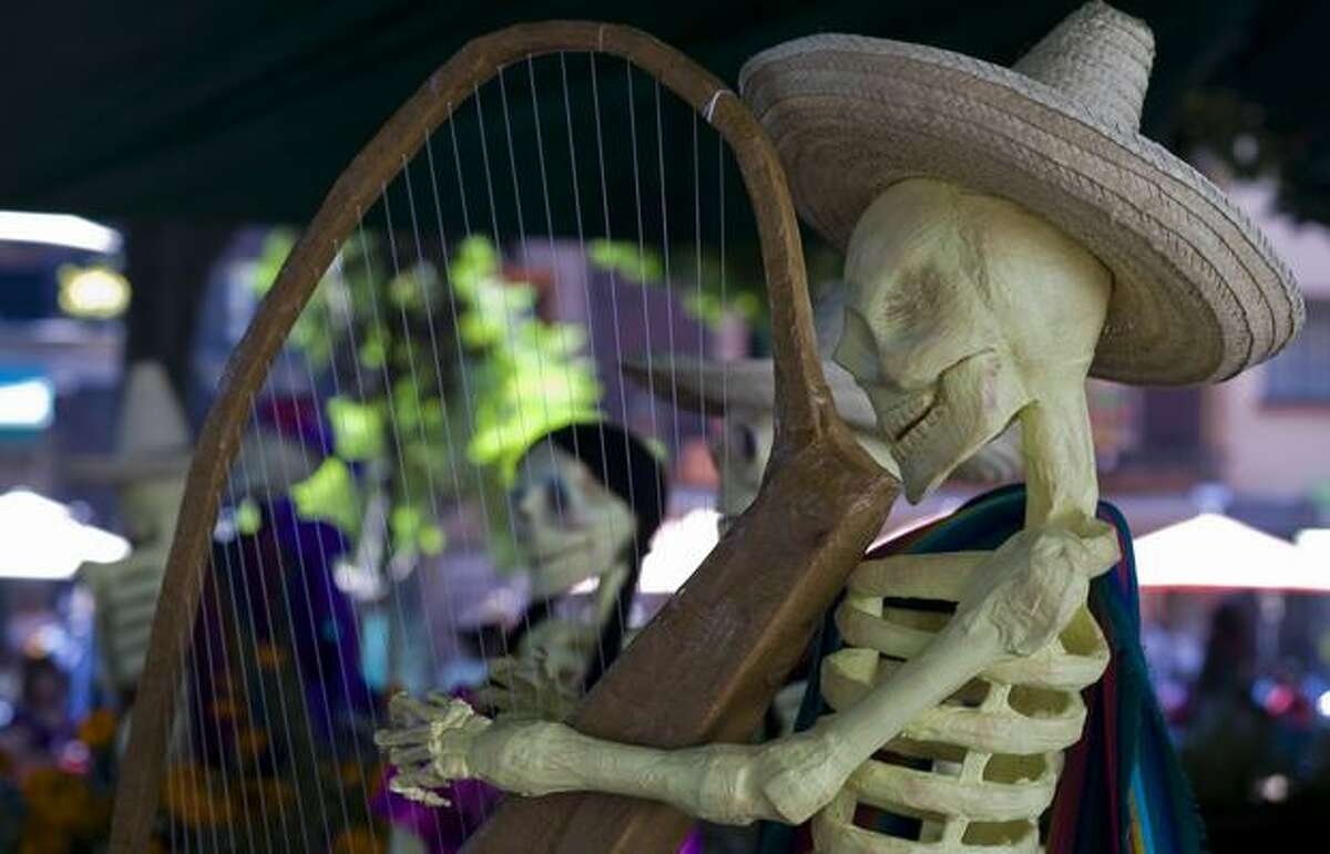 A skeleton as representation of the dead playing a harp in an Altar of the Dead at one of the parks in Mexico City on Sunday. Mexicans celebrate the Day of the Dead on November 1 and 2 in connection with the Catholic holy days of All Saints' Day and All Souls' Day. (OMAR TORRES/AFP/Getty Images)