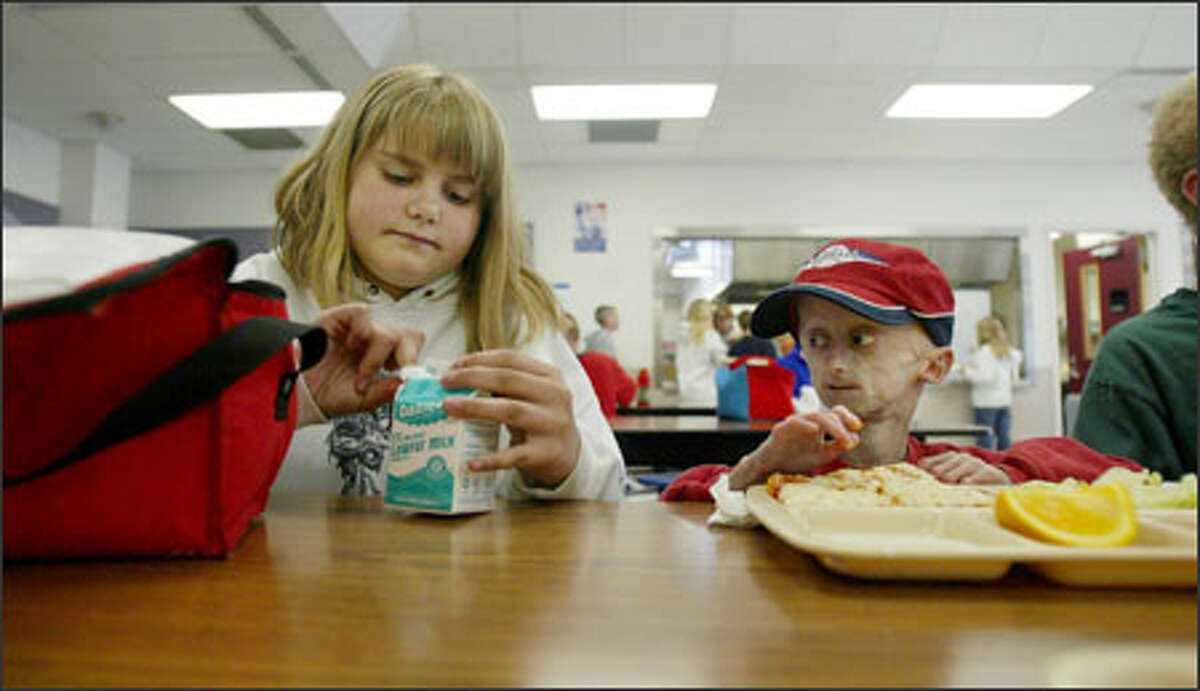 Seth gets some help at lunch from his cousin Emily, whom he calls his "can opener." Arthritis in his fingers makes it difficult for Seth to open containers and packages, so he often relies on Emily, who eats at his table every day.