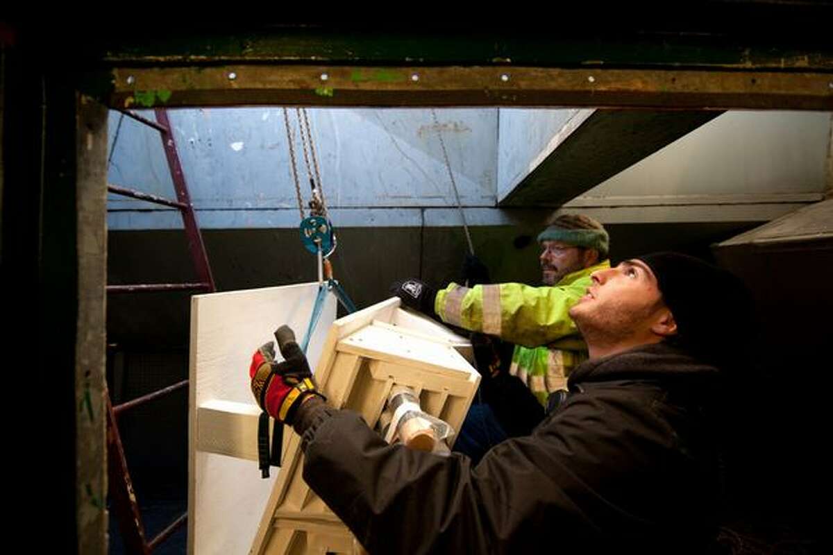 A pyrotechnic crew installs fireworks atop Seattle's landmark Space Needle in preparation for a New Year's show that will welcome in 2011. The crew started the installation early Thursday morning.