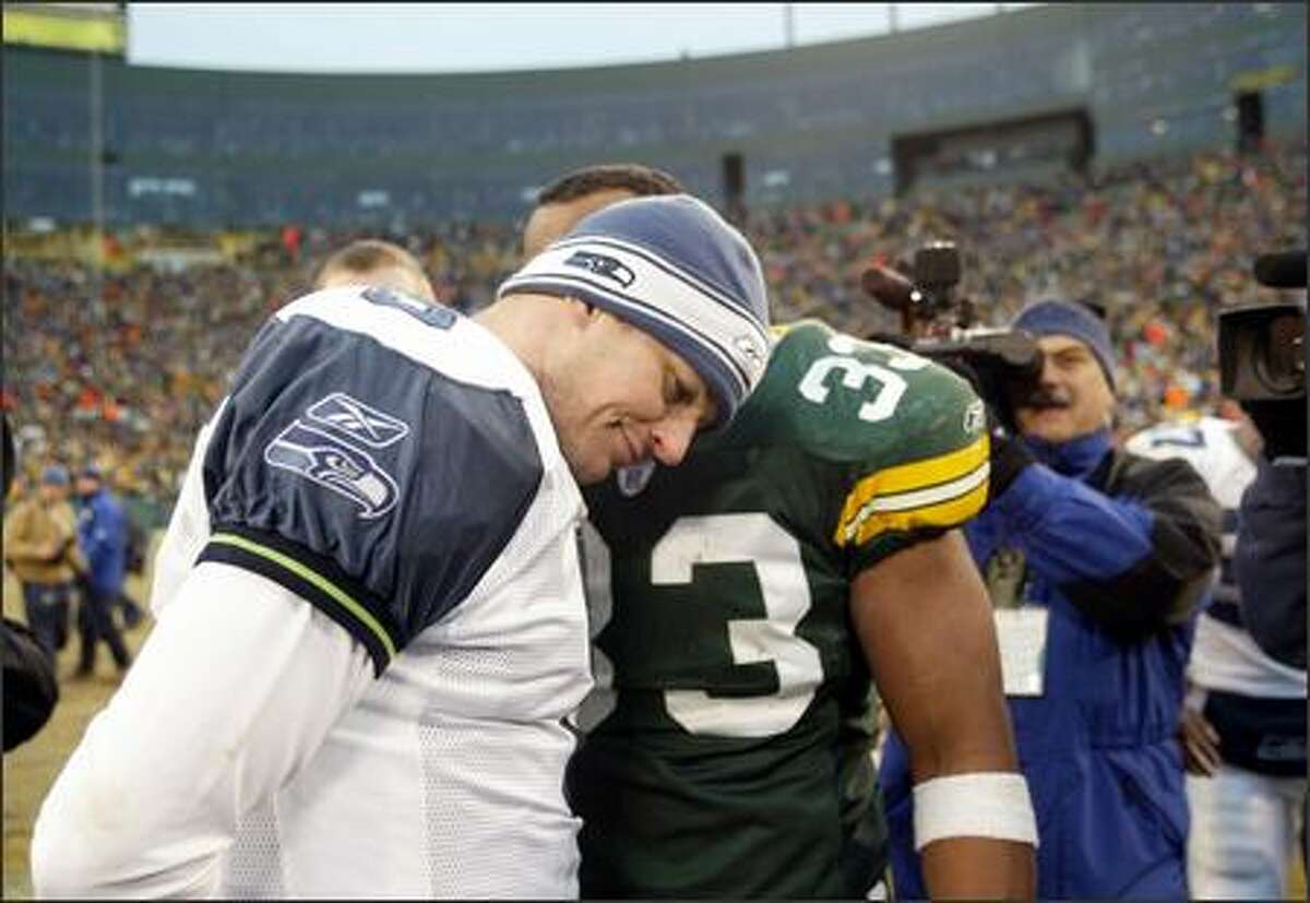 Seahawks quarterback Matt Hasselbeck gets consoled by former teammate William Henderson (33) after giving up the game-winning interception in overtime.