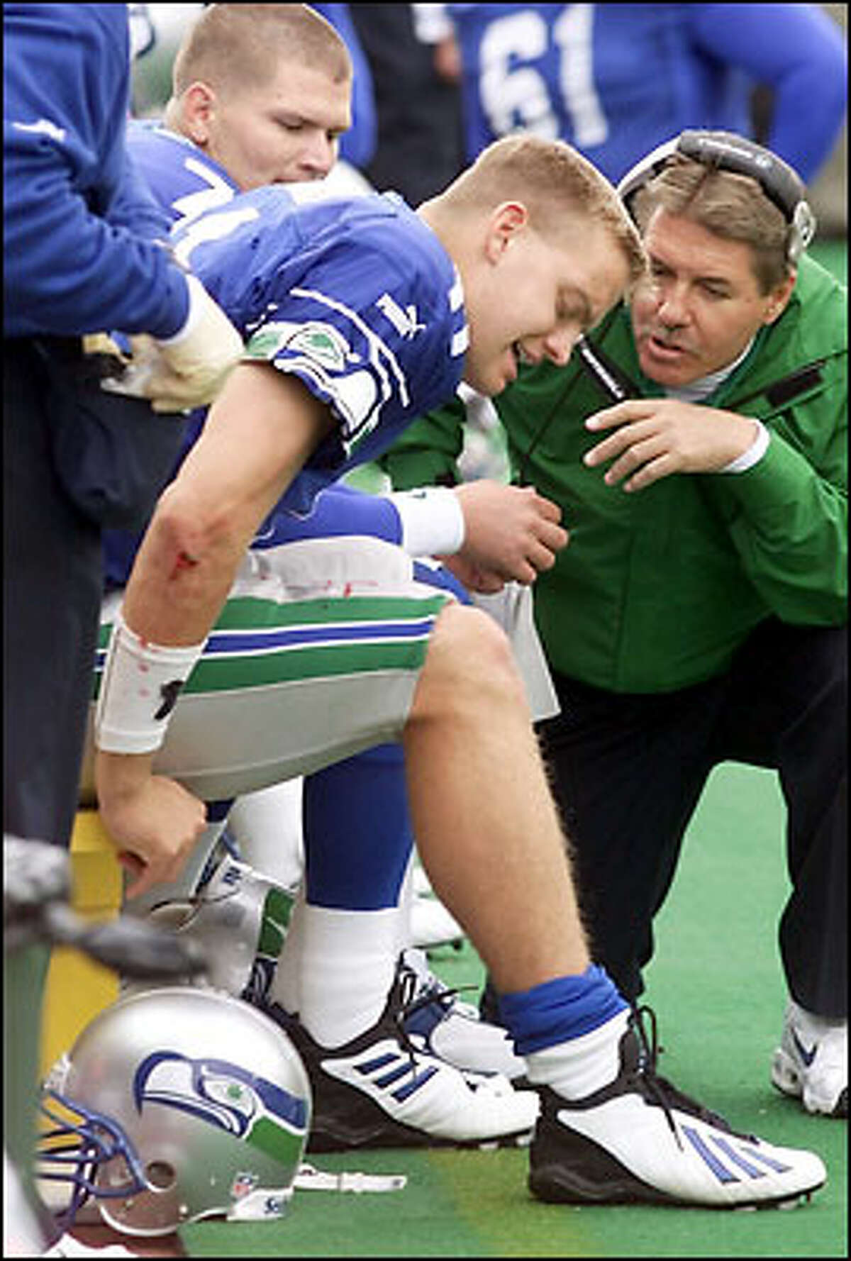 Seahawks QB Brock Huard is checked for a knee injury, one that forced him twice to leave the game.