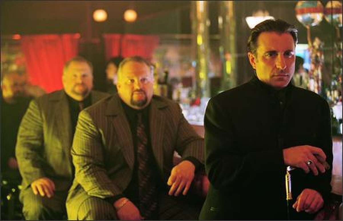 Ruthless entrepreneur Terry Benedict (Andy Garcia) would love nothing more than exacting revenge on the brash crew who robbed $160 million from his casinos –- especially their ringleader, Danny Ocean (George Clooney), who stole Benedict’s girlfriend in the process. The power twins David and Larry Sontag are in the background.