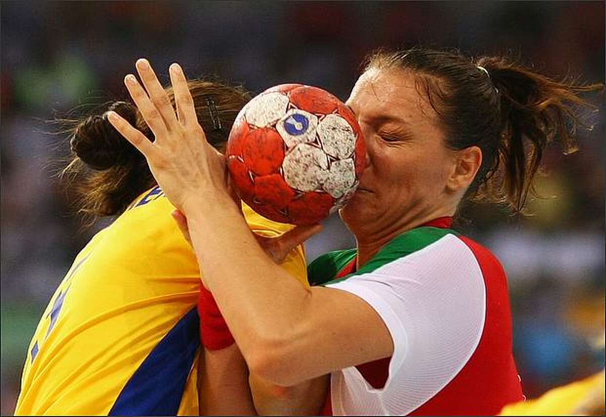 Timea Toth (R) of Hungary is tackled by Sara Holmgren of Sweden during the handball match between Hungary and Sweden held at the Olympic Sports Center Gymnasium during day 1 of the Beijing 2008 Olympic Games in Beijing, China.