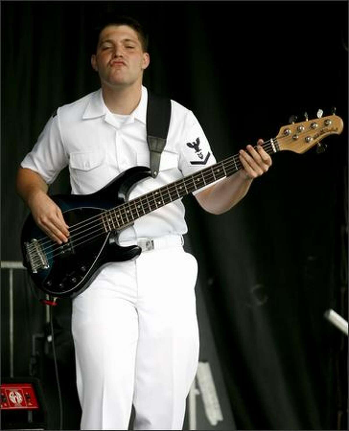 The South by Northwest bass guitar player gets his groove on at Seafair on Saturday. (Kristine Paulsen/P-I)