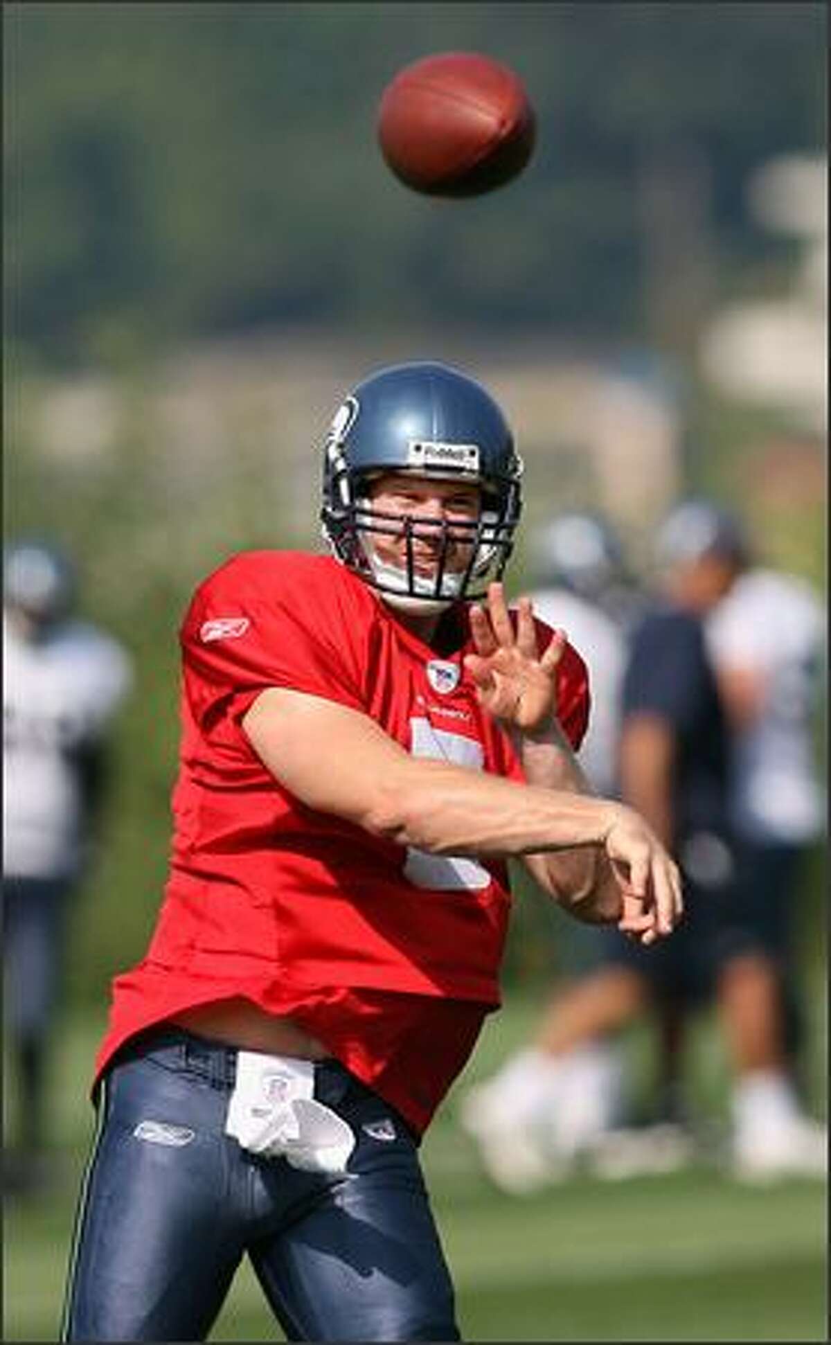 Backup quarterback Charlie Fry fires a pass as the Seahawks hold their first practice at their new practice facility.