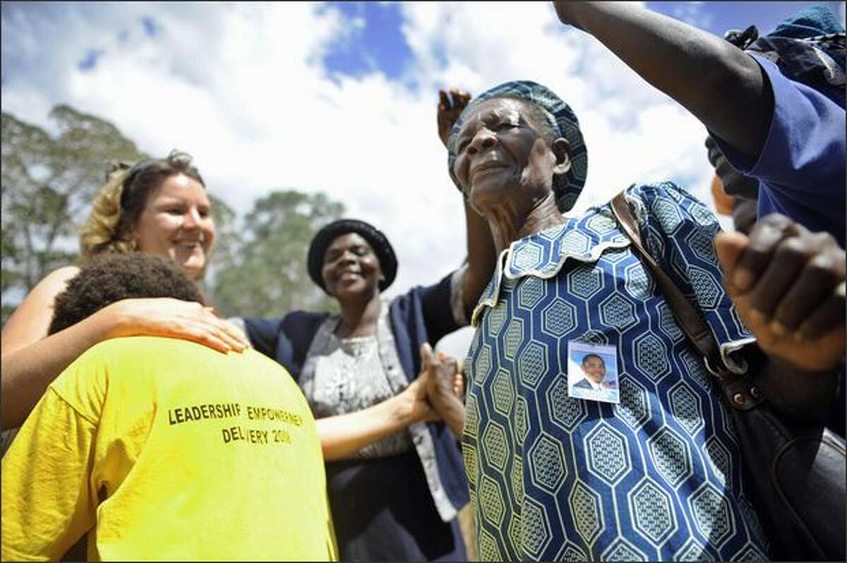 American tourists are welcomed on Sunday by villagers of Nyang'oma in Kogelo, Kenya's Nyanza province. Two days to Obama's historic installation as President of the U.S., Nyang'oma, the birth-village of Barack Obama's Kenyan father, is anything but its usual sleepy self as more and more foreign and local tourists, the press and villagers flock to the village.