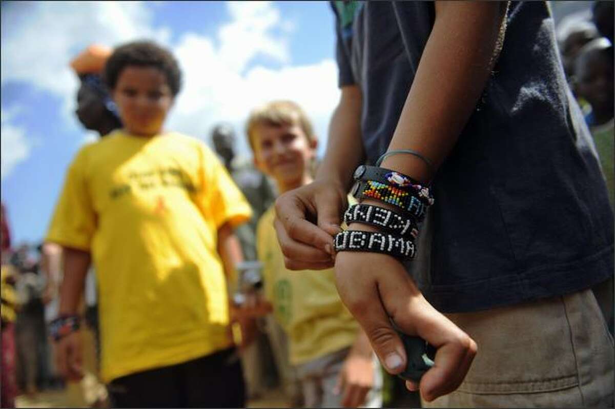 A young US tourist shows an "Obama" bracelet at Nyang'oma in Kogelo, on Sunday during festivities by villagers to celebrate the anticipated inauguration. Two days to Obama's historic installation as President of the U.S., Nyang'oma, the birth-village of Barack Obama's Kenyan father, is anything but its usual sleepy self as more and more foreign and local tourists, the press and villagers flock to the village.