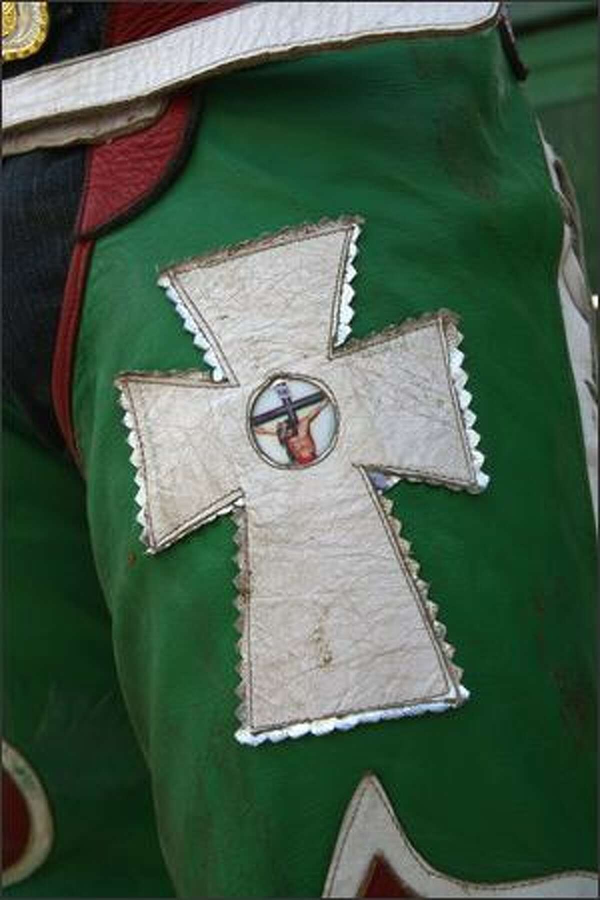 An image representing Jesus Christ on the cross adorns a pair of chaps.
