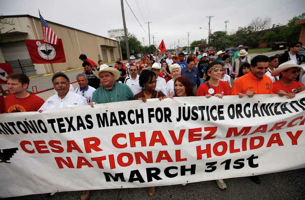 Grand marshal Raulito Navaira (third from front left) joins others carrying a banner to mark the 15th annual Cesar Chavez March for Justice on Saturday, Mar. 26, 2011 as participants made their way along Frio Street. Kin Man Hui/kmhui@express-news.net