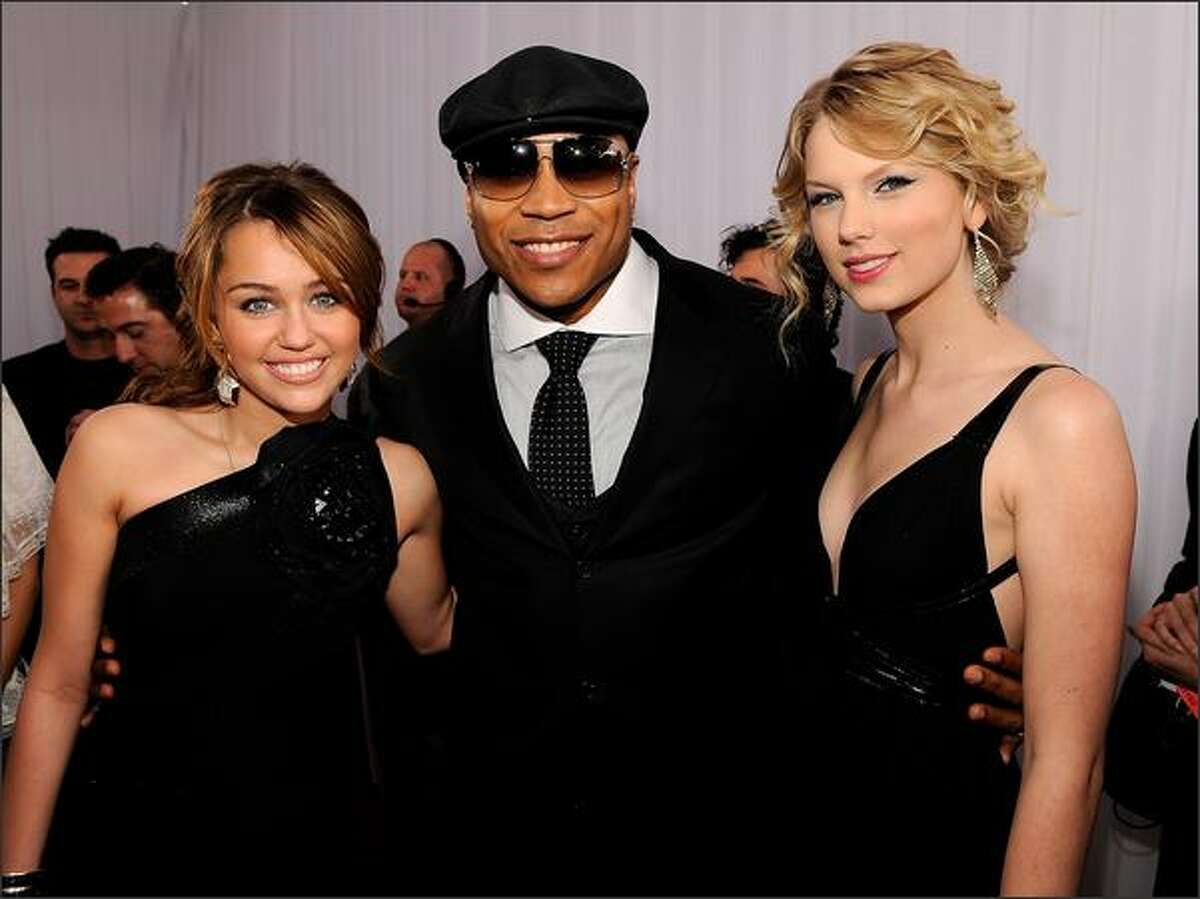 From left, singer Miley Cyrus, rapper/actor LL Cool J, and singer Taylor Swift arrive.