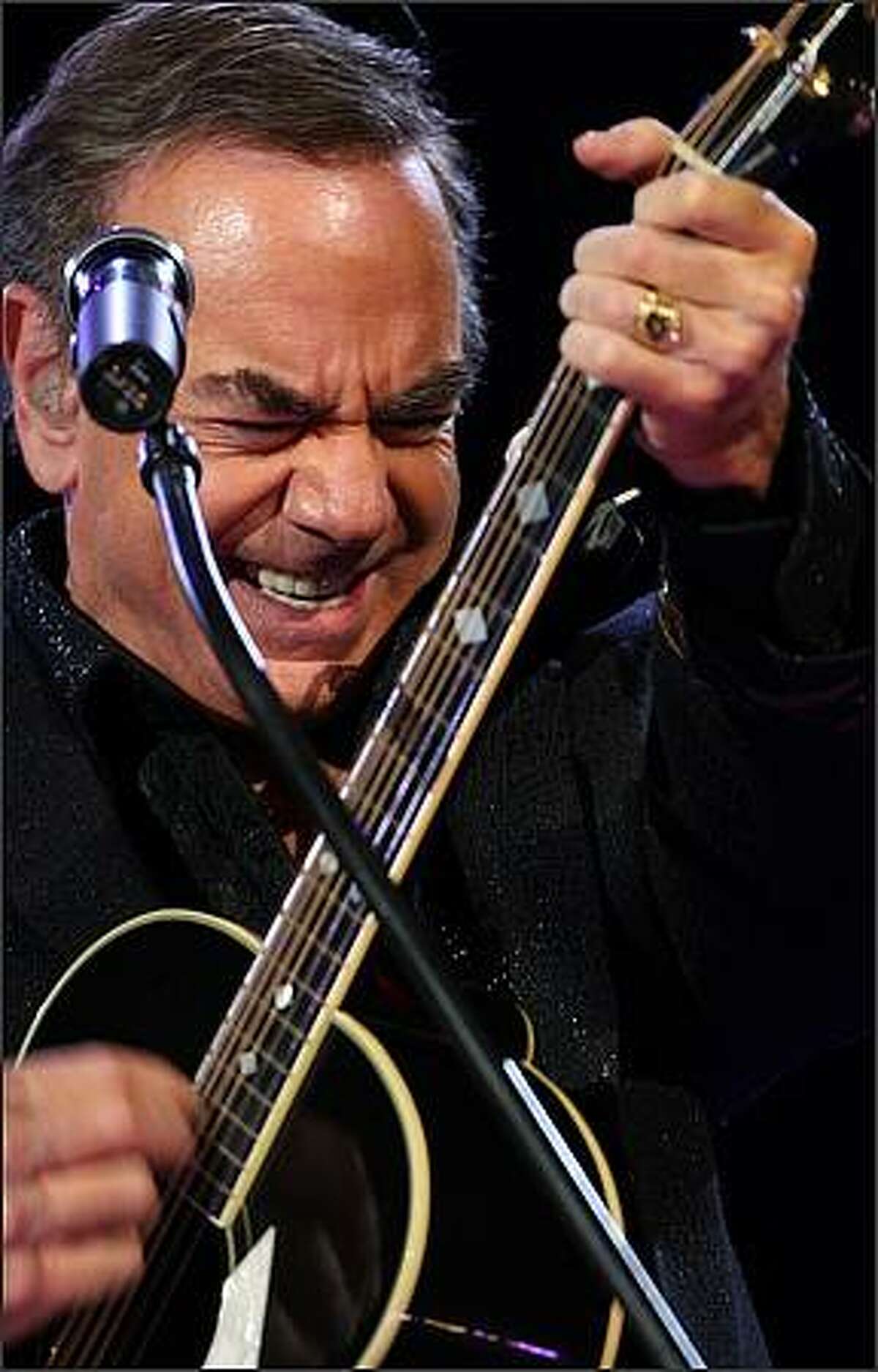Neil Diamond gives his guitar a workout at Key Arena on Wednesday night.