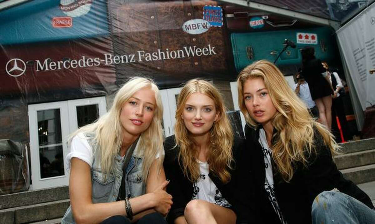 From left, models Raquel Zimmermann, Lily Donaldson and Doutzen Kroes pose during the Bryant Park preparation.