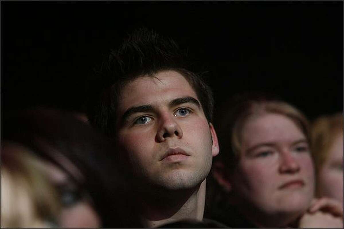 A concert goer listens to Aqueduct perform at the 2008 Deck The Hall Ball concert at the WaMu Theater.
