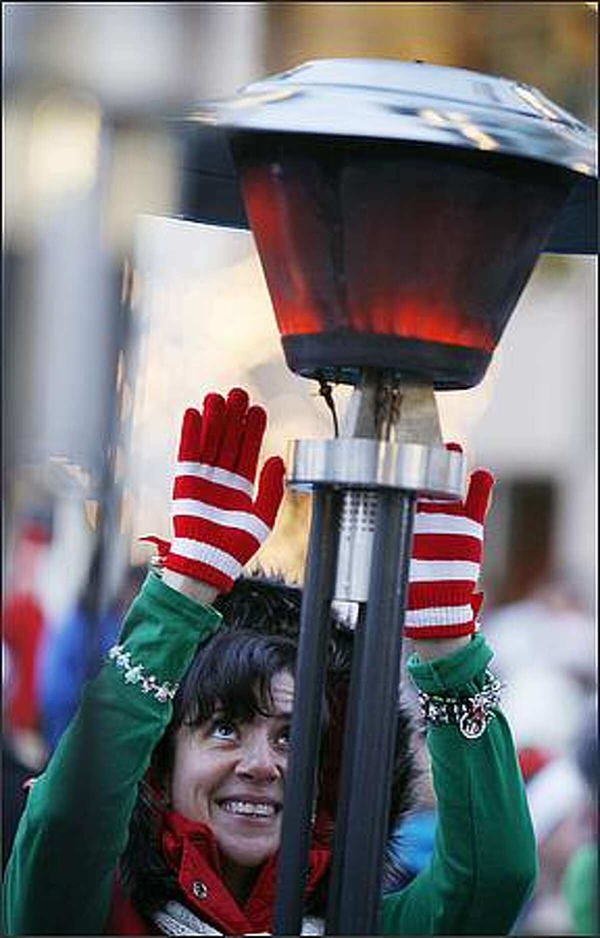 Jennifer Covey tries to stay warm before the start of the 24th Annual Jingle Bell Run.