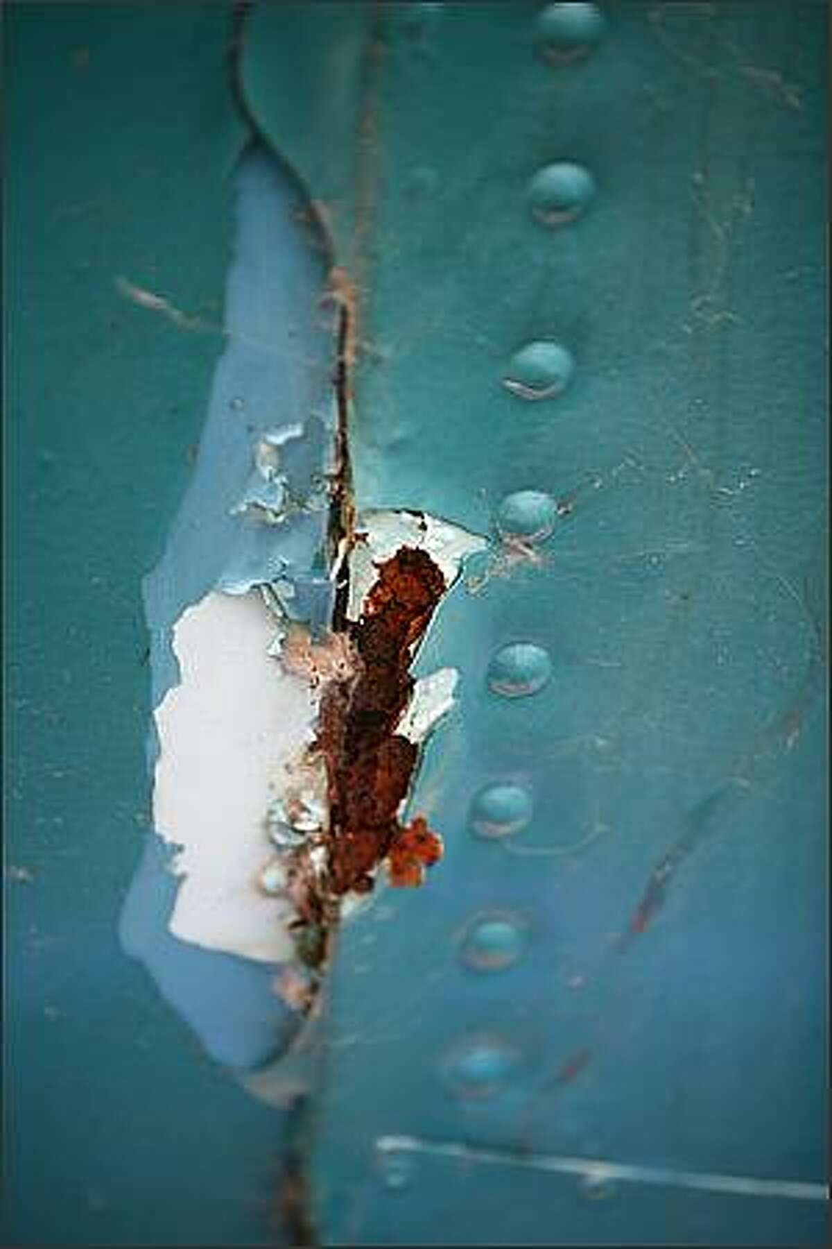 Rust can be seen on the Seattle P-I's signature globe atop the Seattle P-I's waterfront building in Seattle. Andy Colton, who helps maintain the globe said that structurally the globe is sound. However, its skin is rusting and he said working on the globe is like "putting a screw into a saltine cracker."
