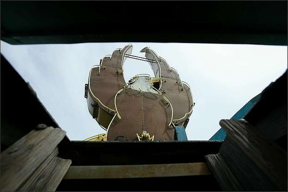 The eagle is seen through a hatch on the top of the Seattle P-I globe.