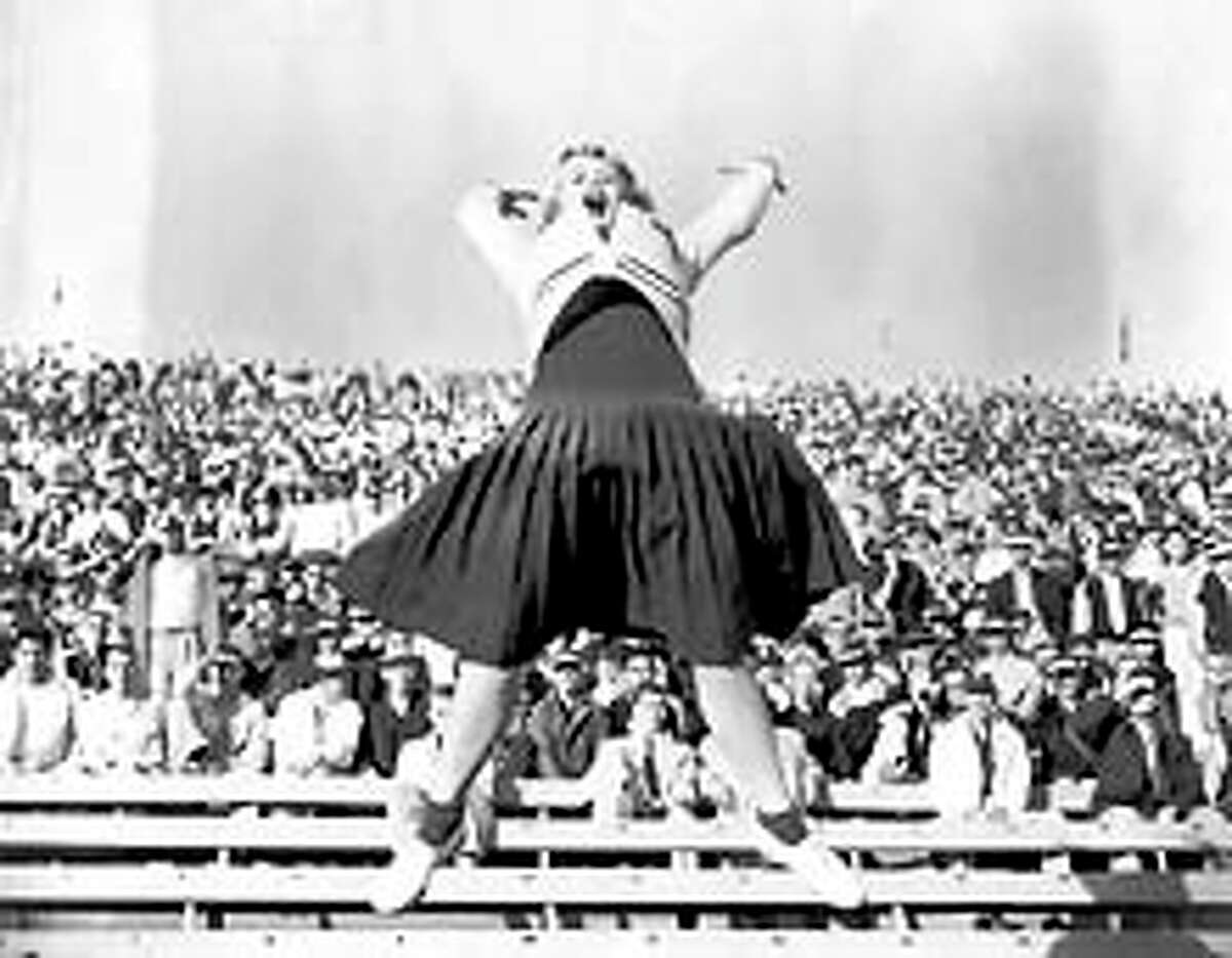 Dorothy "Dottie" Provine, 19-year old University of Washington sophomore, had plenty to shout about during the first half of the Washington vs. Oregon game, as the Huskies led 7-6. October 31, 1954. She went on to become an actress, playing Pinky in the 60s TV show "Roaring Twenties" and appearing in "Mad Mad World" and other films. P-I Photograph by James Huff.
