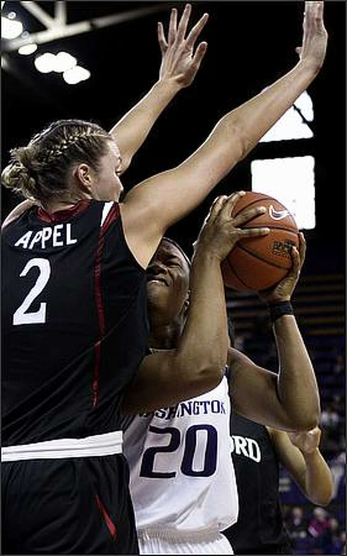 Washington's Liz Lay runs into the defense of Stanford's Jayne Appel during the first half.