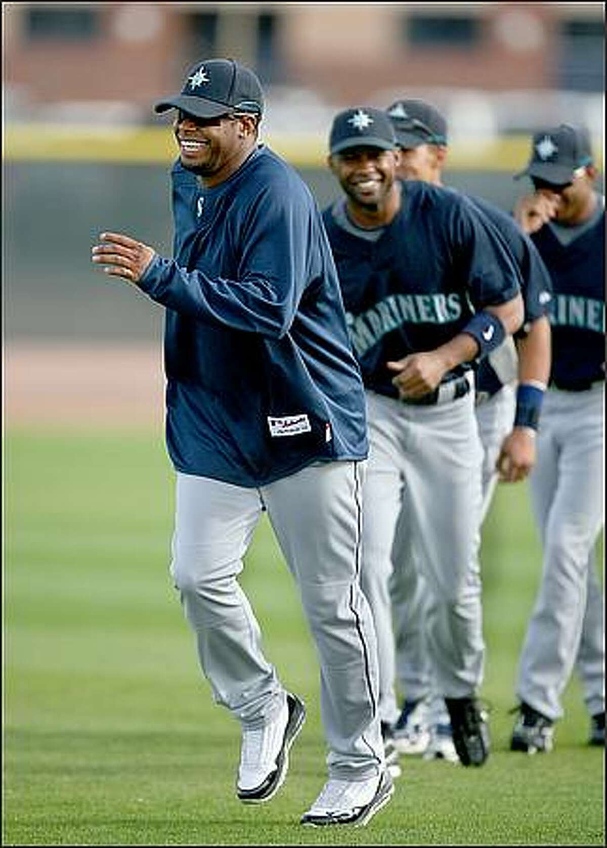 Ken Griffey Jr. warms up with a slow jog as he participates in his first team workout at the Seattle Mariners' spring training facility in Peoria, Ariz.