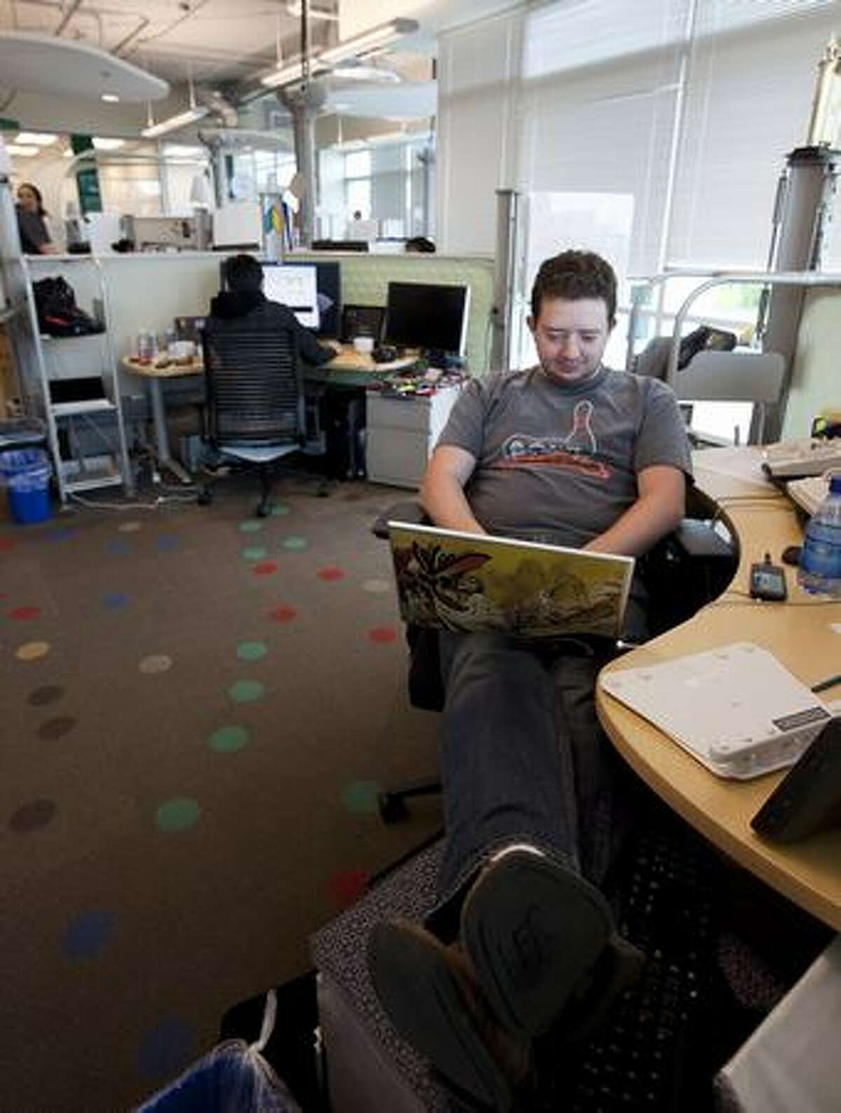 Google software engineer Greg Millam works at his desk at Google Kirkland on Wednesday.