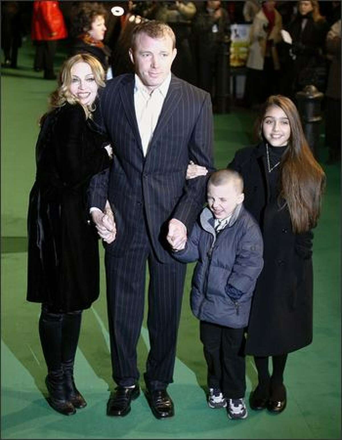 Madonna and then-husband Guy Ritchie stand with their children Rocco and Lourdes as they attend the premiere of the film "Arthur and the Invisibles" in Leicester Square, London, Jan. 25, 2007.
