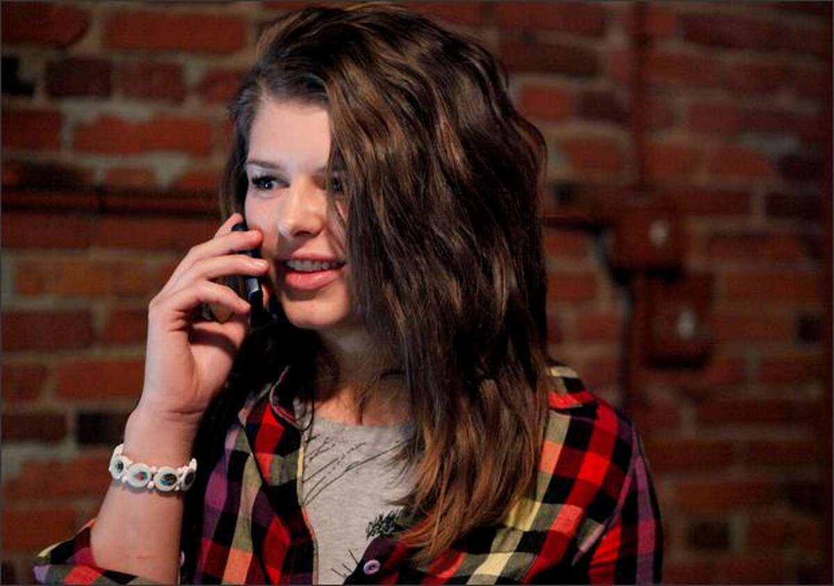 Elaine Easton calls a friend after auditioning at the MTV Real World casting call at Fuel Sports Eats and Beats in Seattle on Saturday.