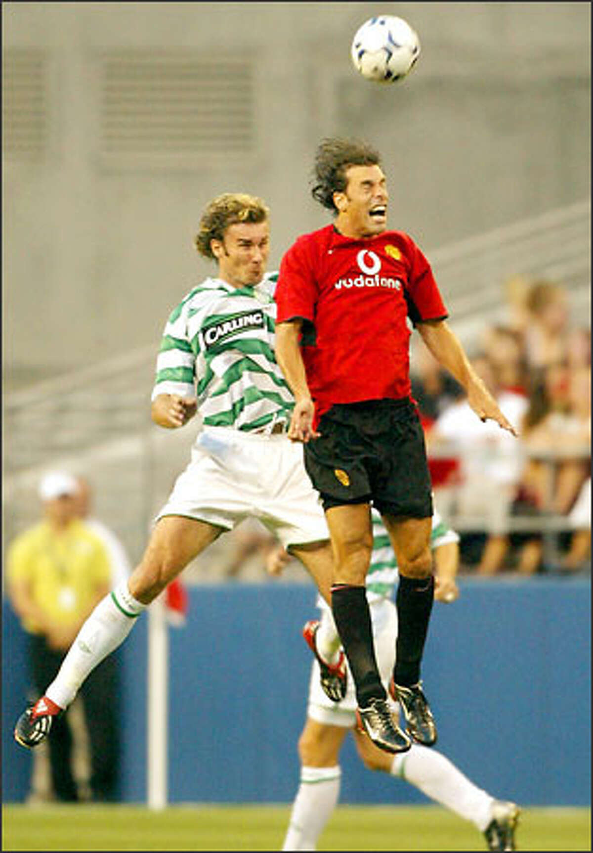 Celtic's Craig Beattie, left, and Manchester United's Ruud van Nistelrooy do their thing during first-half action at Seahawks Stadium. Nistelrooy scored Man U's first goal and set up the second.