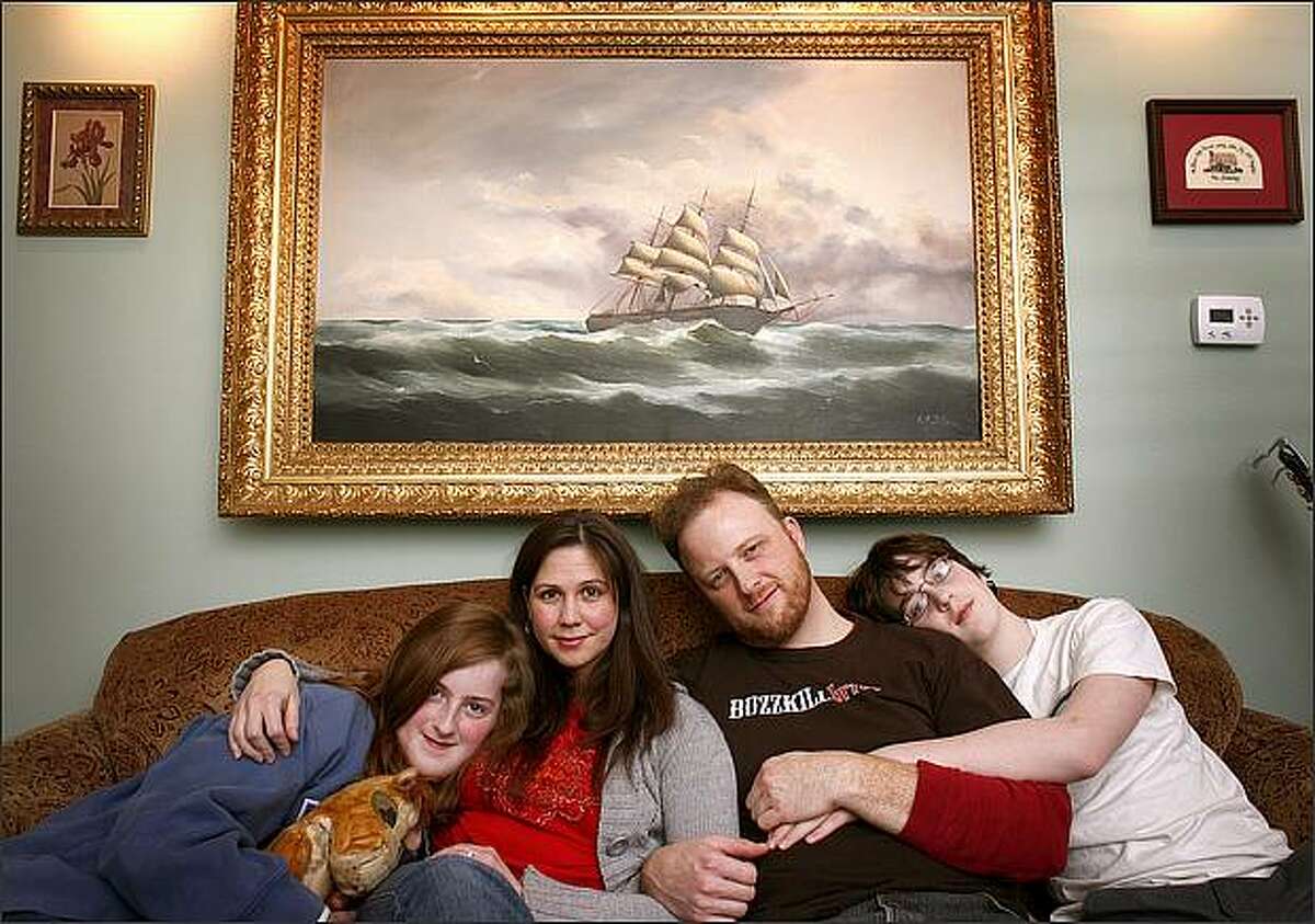 From left: Kayleigh Downing, 11, Raechelle Marsh, Todd Downing and Tyler Downing, 14, relax on the couch of their rebuilt home in Seattle on April 2. Above them is an heirloom painting that survived the flood and then the fire that destroyed Todd and his children's house. Before the fire and flood, Todd lost his wife -- and the children lost their mother -- to cancer. Downing also lost his father to cancer that year. Since the string of tragedies a few years ago, Todd has become engaged to Marsh and returned to his rebuilt home.