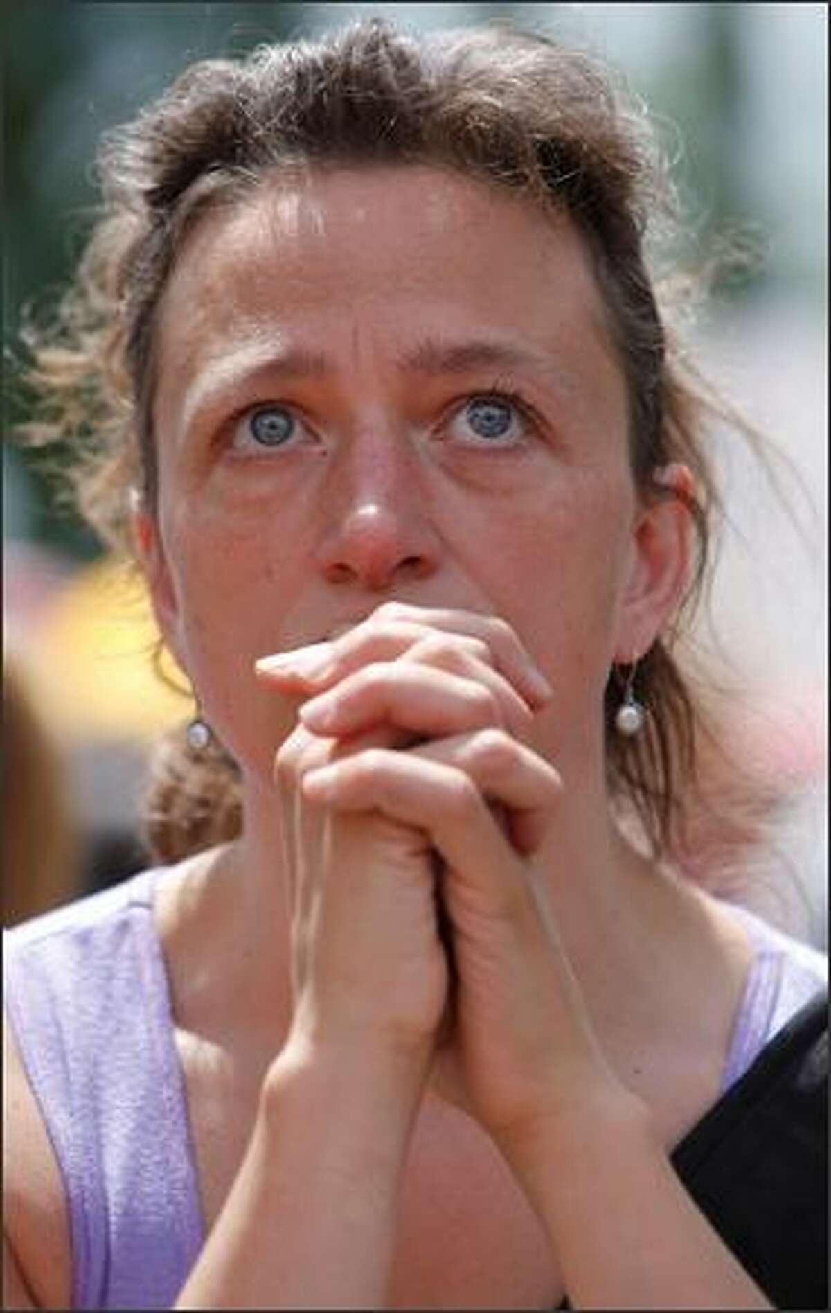 Seattle resident Jen Vetrovs tears up while hearing a story about a young boy's mother who died.