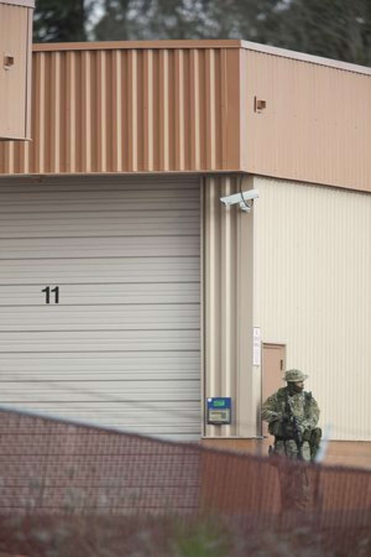 A SWAT team member takes part in the search of storage units near where four Lakewood Police Officers were killed Sunday near Lakewood. A gunman shot and killed four Lakewood Police Officers in a Forza Coffee Company shop Sunday morning in what authorities are describing as a targeted attack.