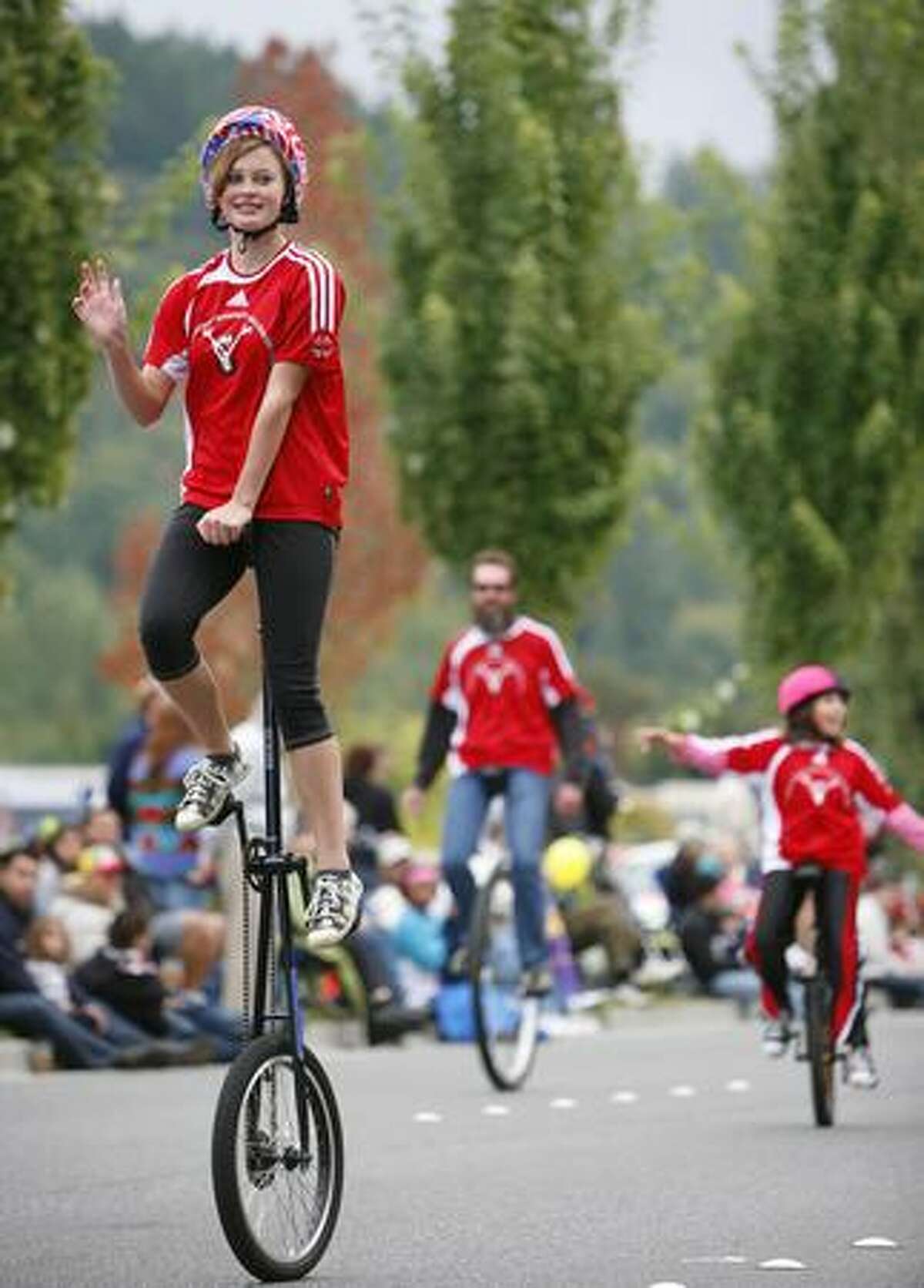 Members of Panther Pride Unicycle Team perform during the Issaquah Salmon Days Festival parade.