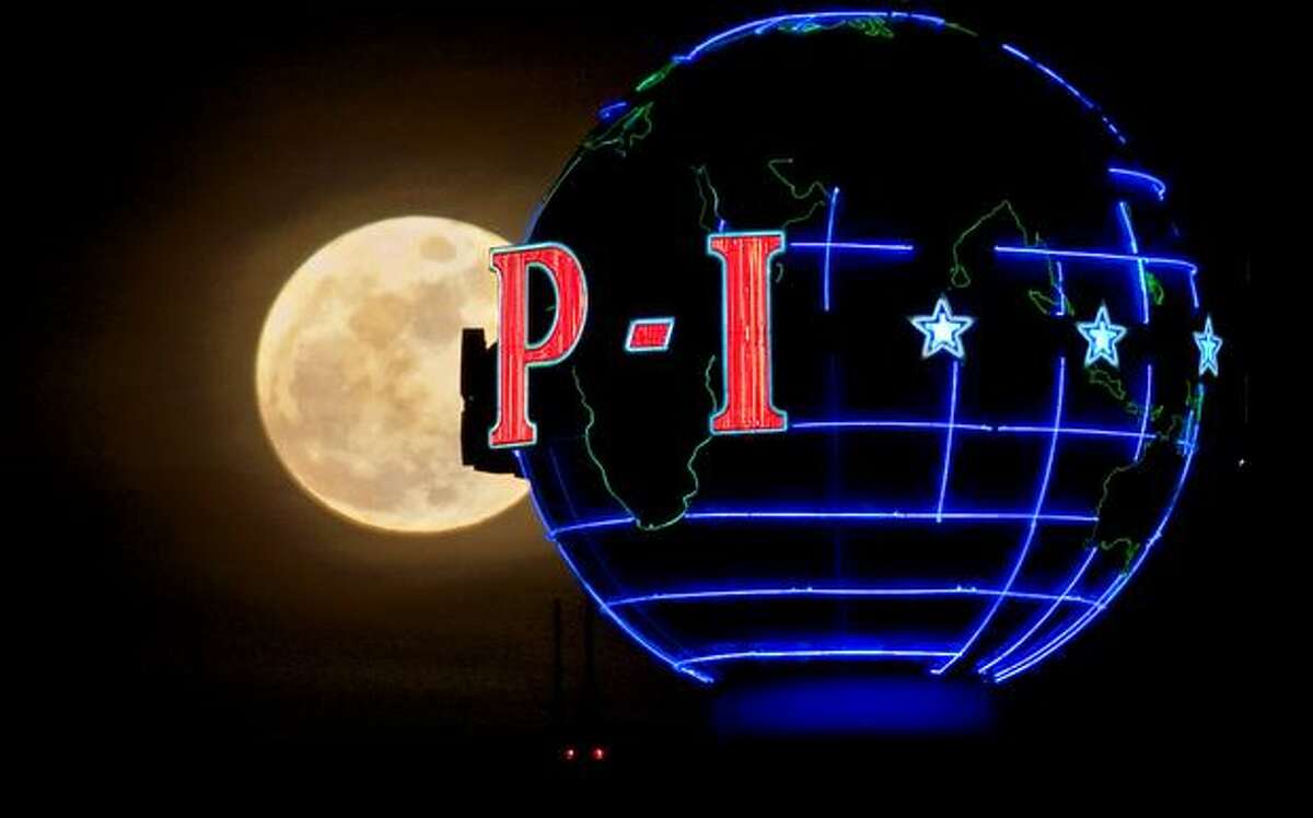 A full moon rises behind the P-I globe on March 6, 2009, 11 days before the newspaper stopped the presses for good.