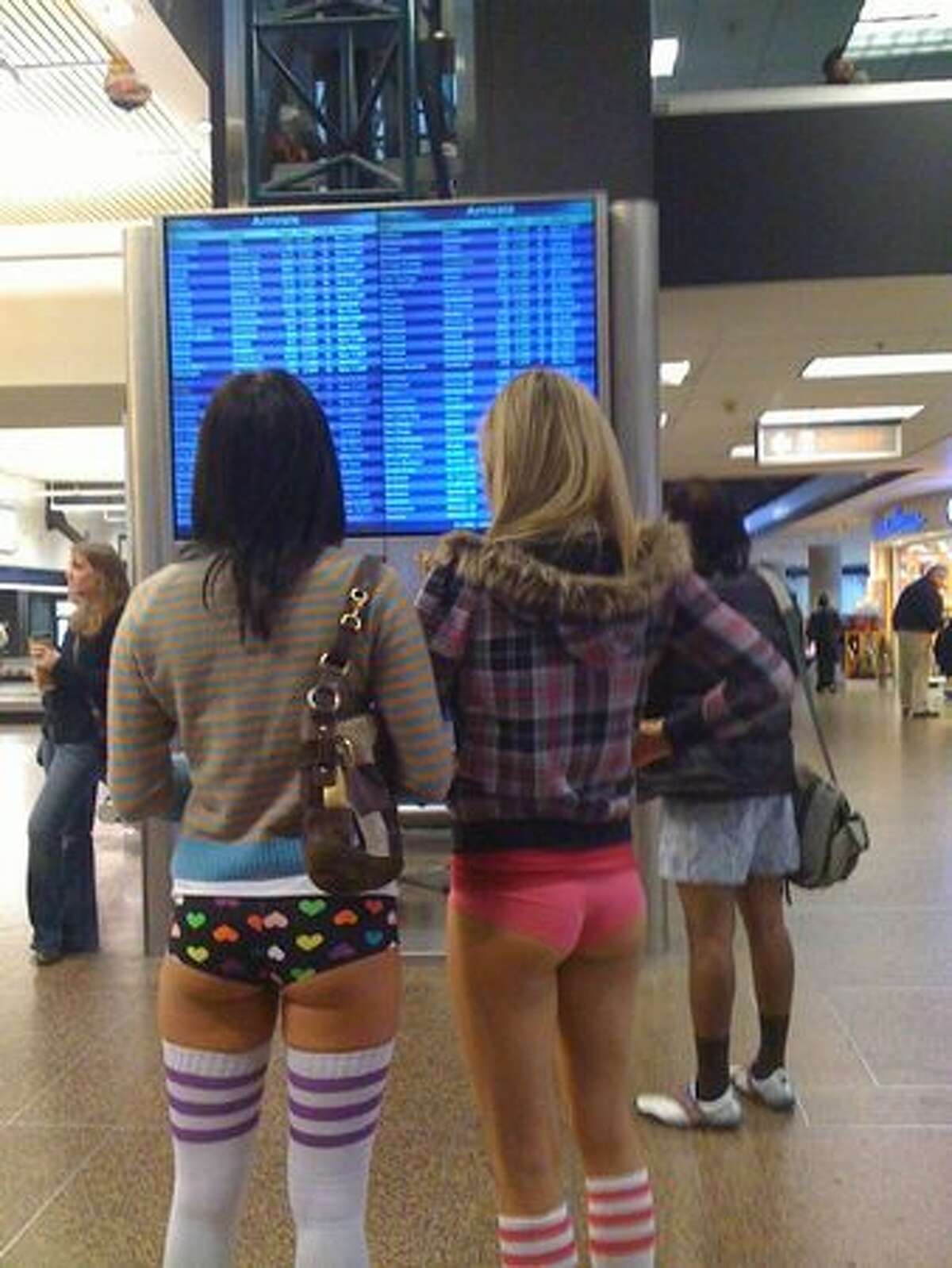 1:35 p.m. -- These women showed no surprise when a small posse of passers-by picked up their trail. They stopped at the departures board. "Where are you going?" someone asked. "Amsterdam, the girl in polka-dot boxers said. "We're going to the red light district." (Mónica Guzmán/seattlepi.com) The back story on the No Pants light rail ride.