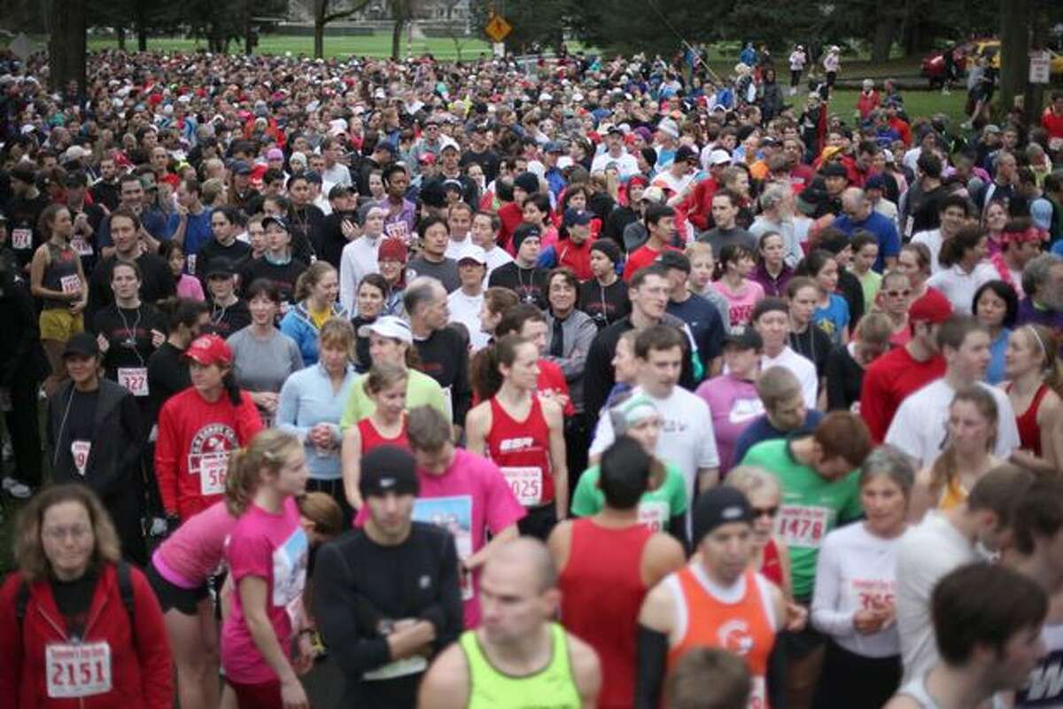 The crowd waits in the starting area on West Green Lake Way N at the Love 'Em or Leave 'Em Valentine's Day Dash in Green Lake on Saturday morning. The 5K run and walk drew approximately 3,000 participants, according to organizers. (David Ryder/seattlepi.com)