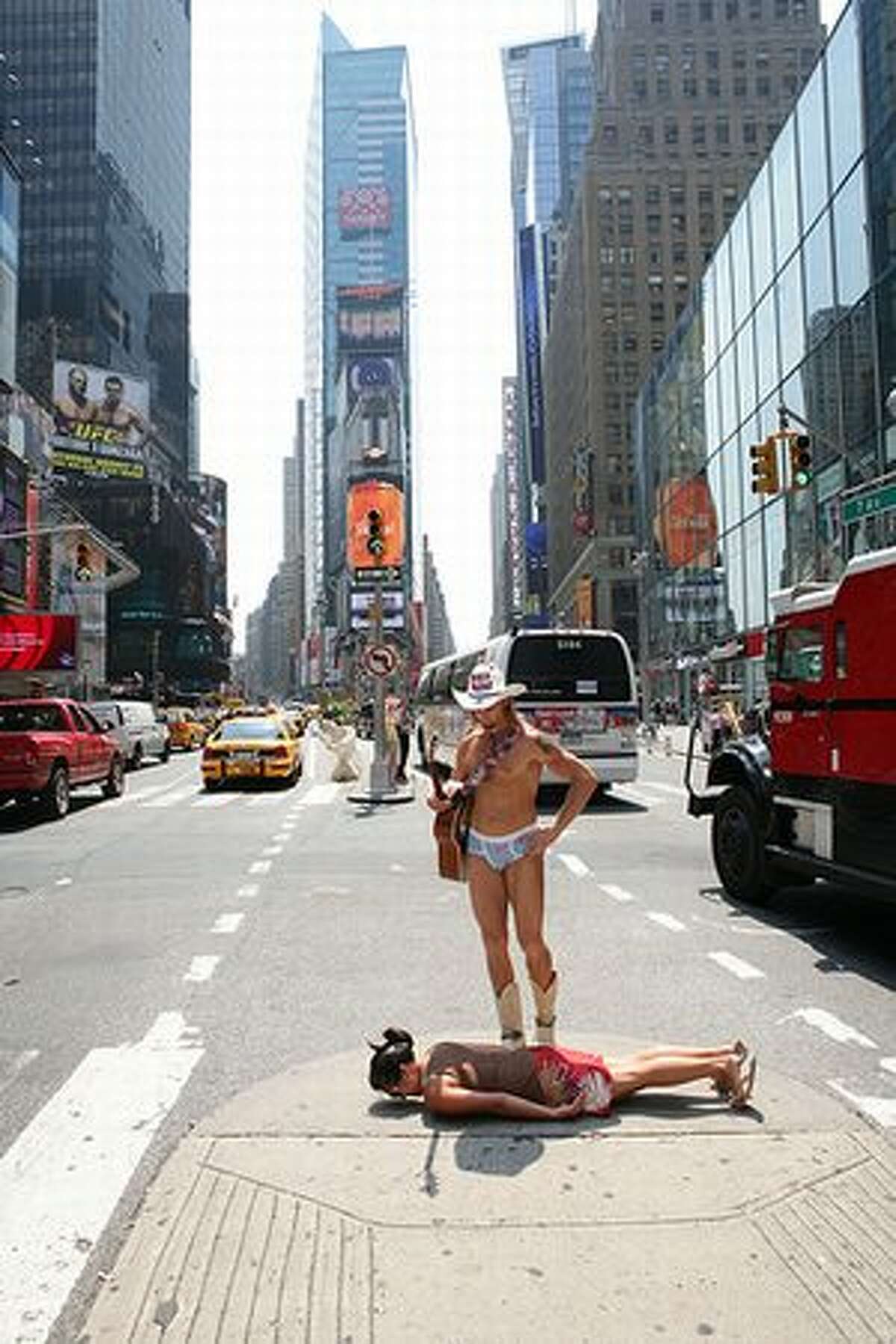 The Naked Cowboy checks out Amy Mihyang in Times Square, New York City. (Russ Heller/Facedowns) See more photos here. Our story on Facedowns, the photo blog.