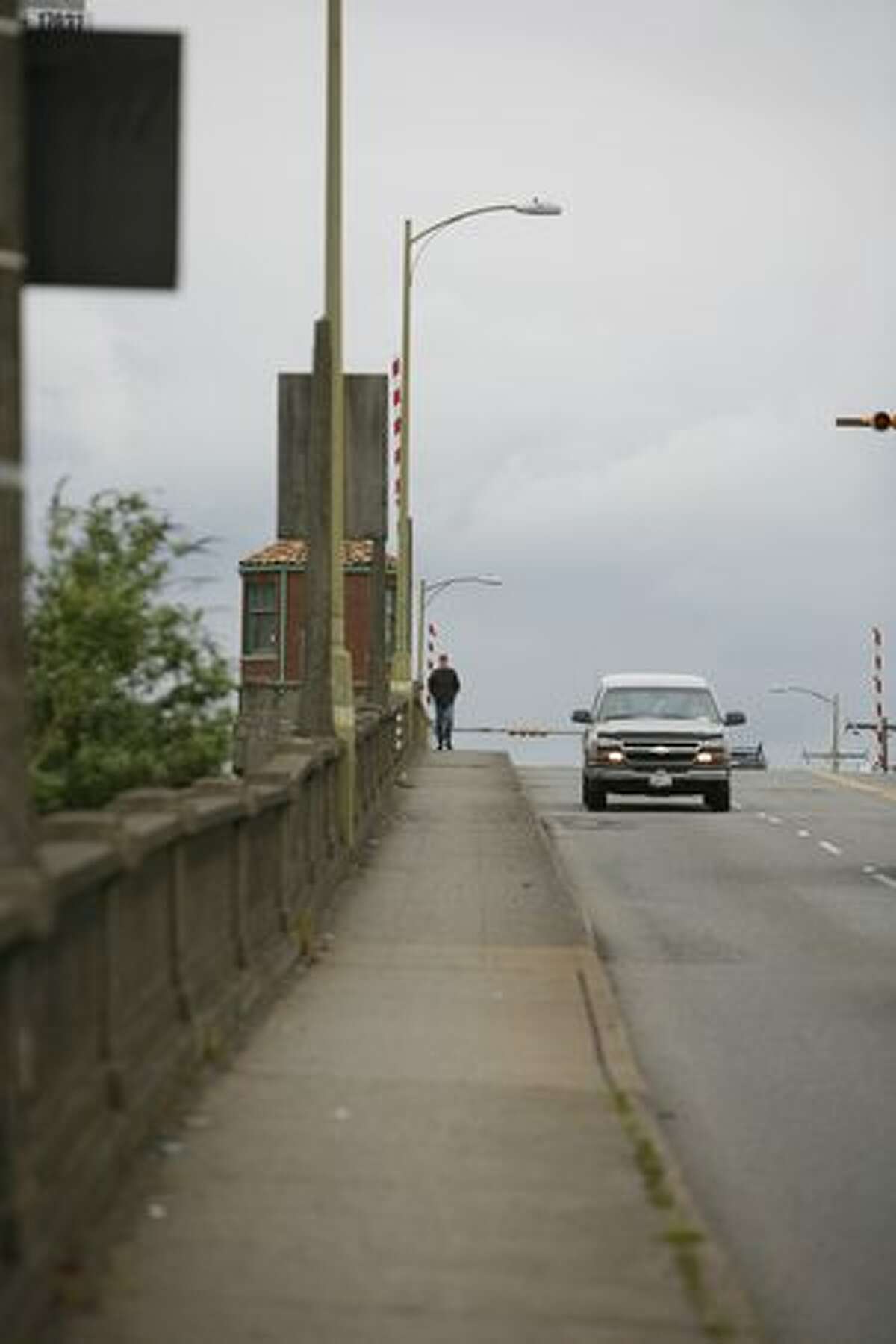 A pedestrian walks along the South Park Bridge on Wednesday.